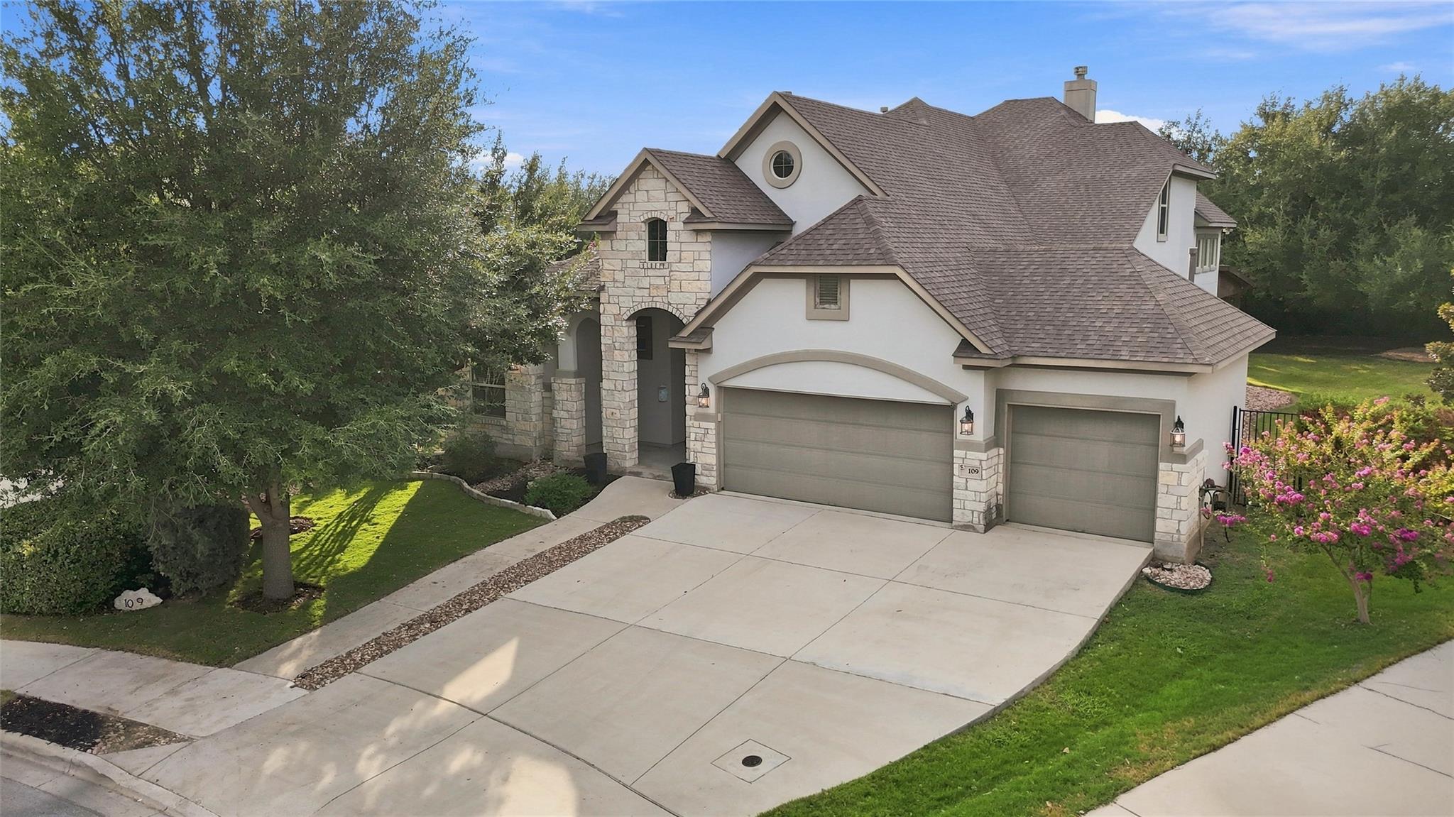 Stately stone masonry and multiple gables create 