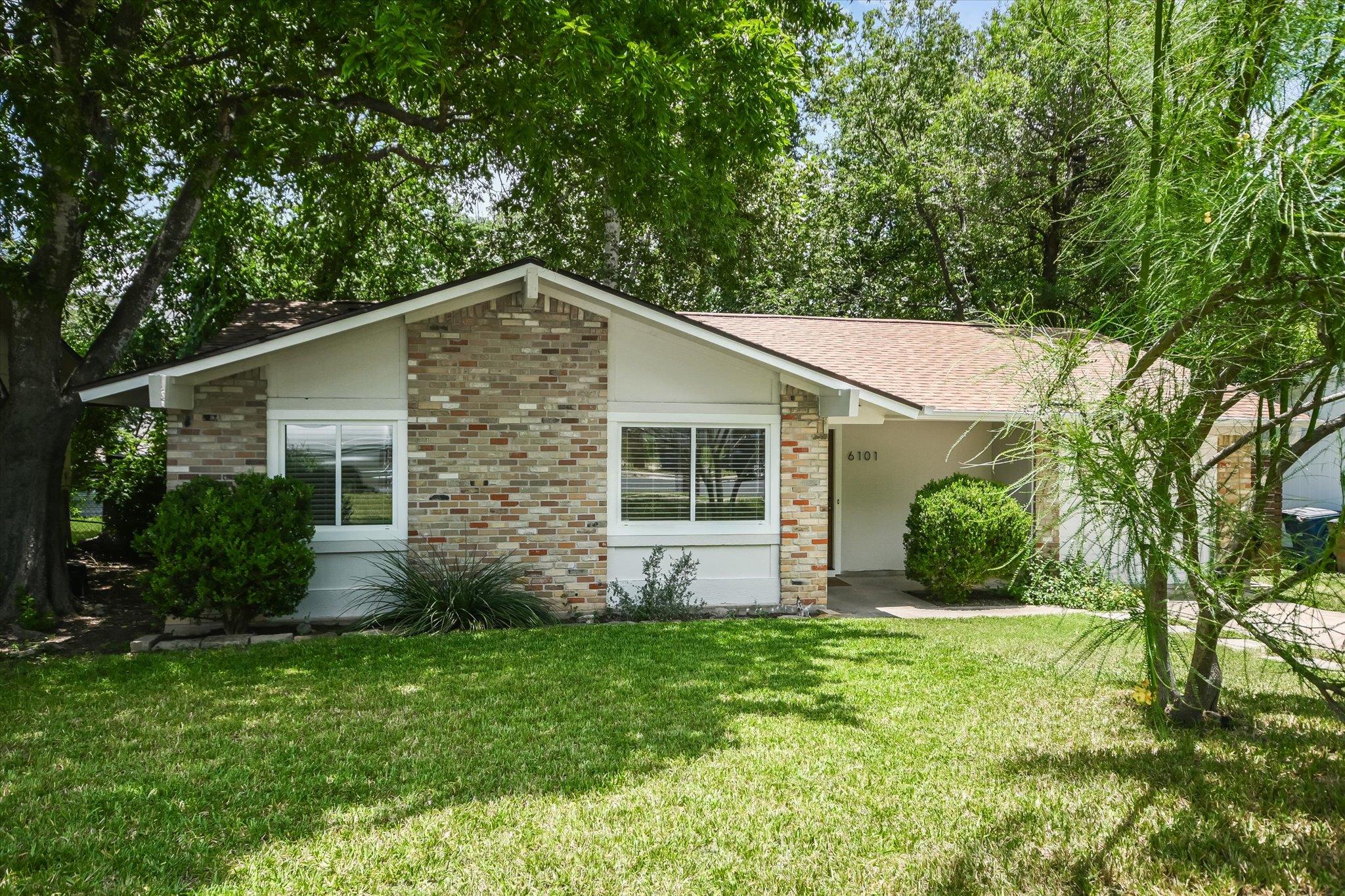 Mature trees canopy this inviting residence with 