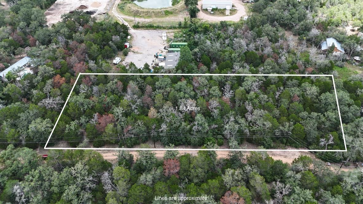 A verdant, 1.84-acre lot offers ample space for b