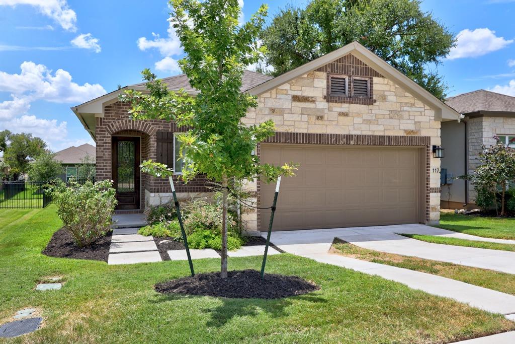 A charming exterior with brick and stone accents,