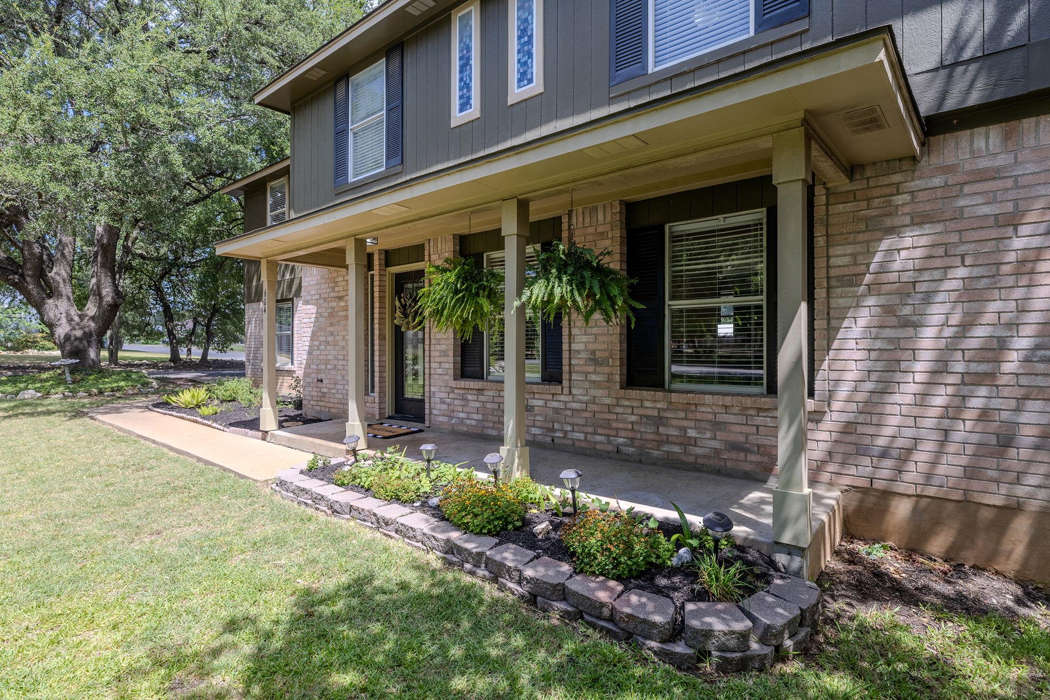 A welcoming brick facade with a covered front por
