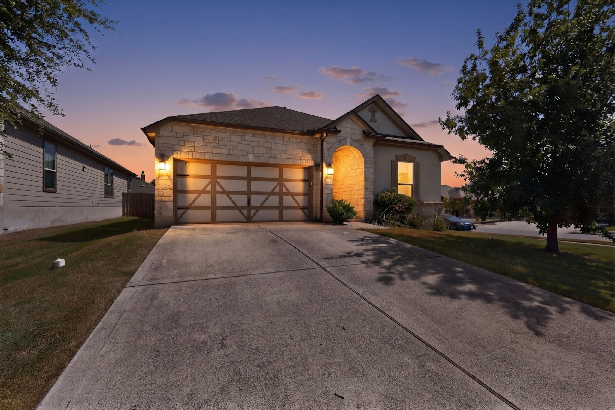 Illuminated by dusk, this home boasts an attached