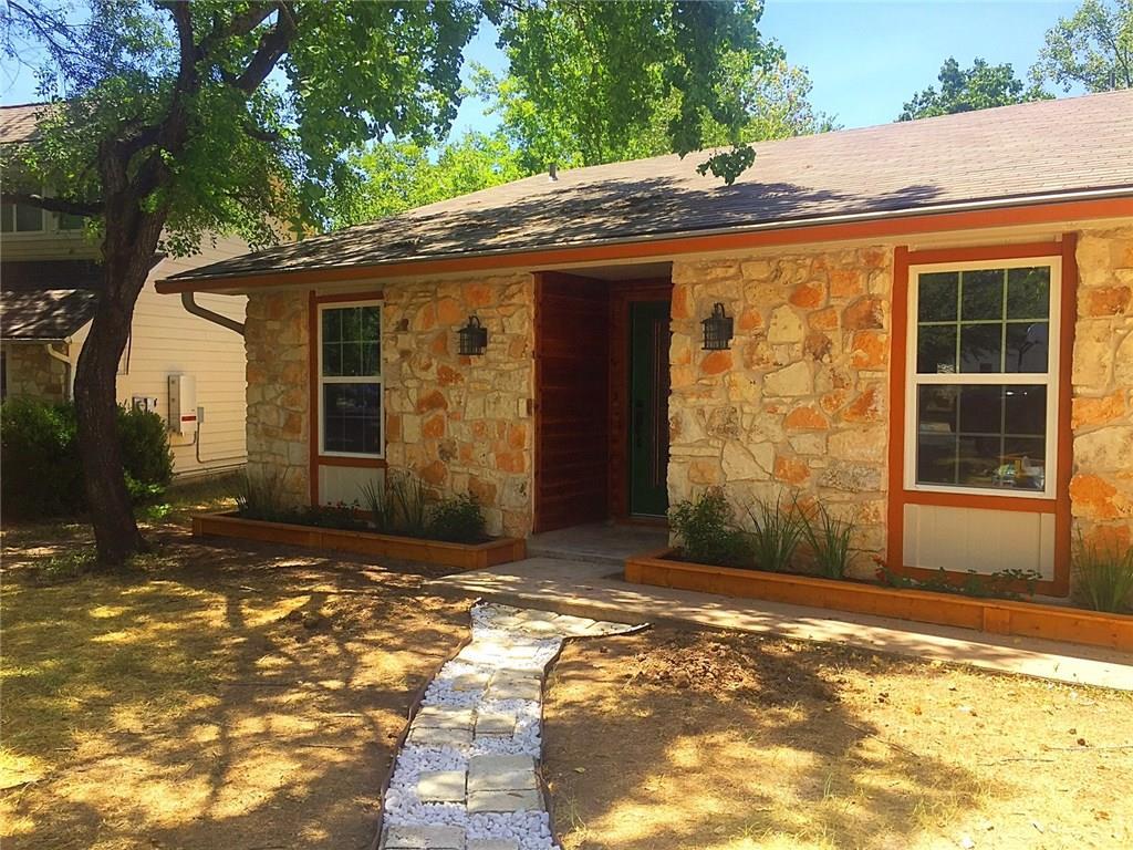 A charming stone facade with warm wood accents we