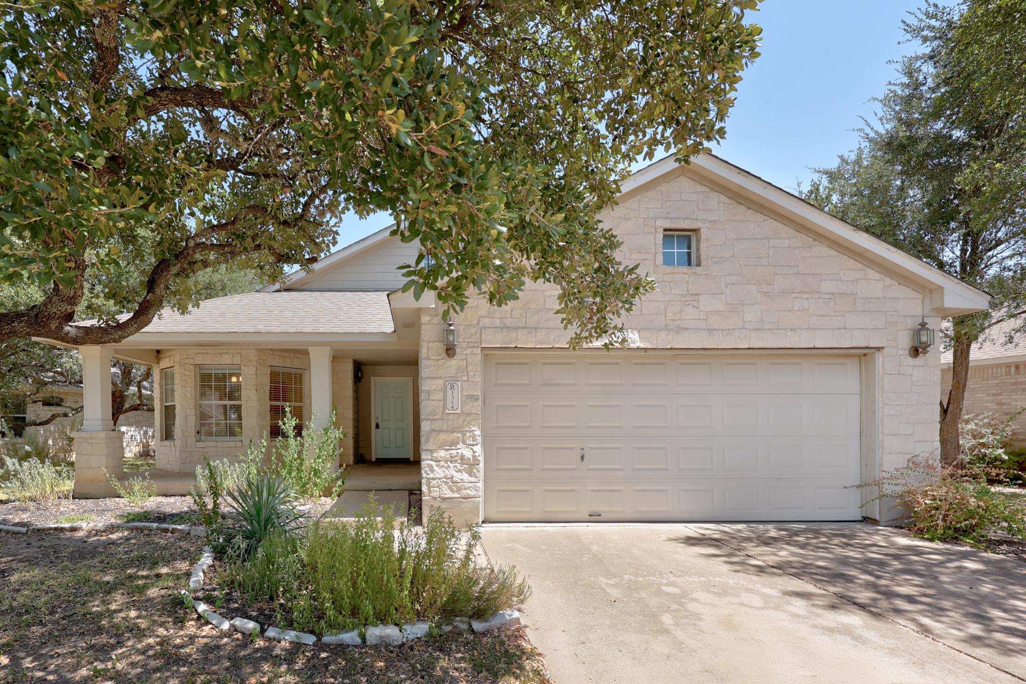 Limestone masonry and mature shade trees frame th
