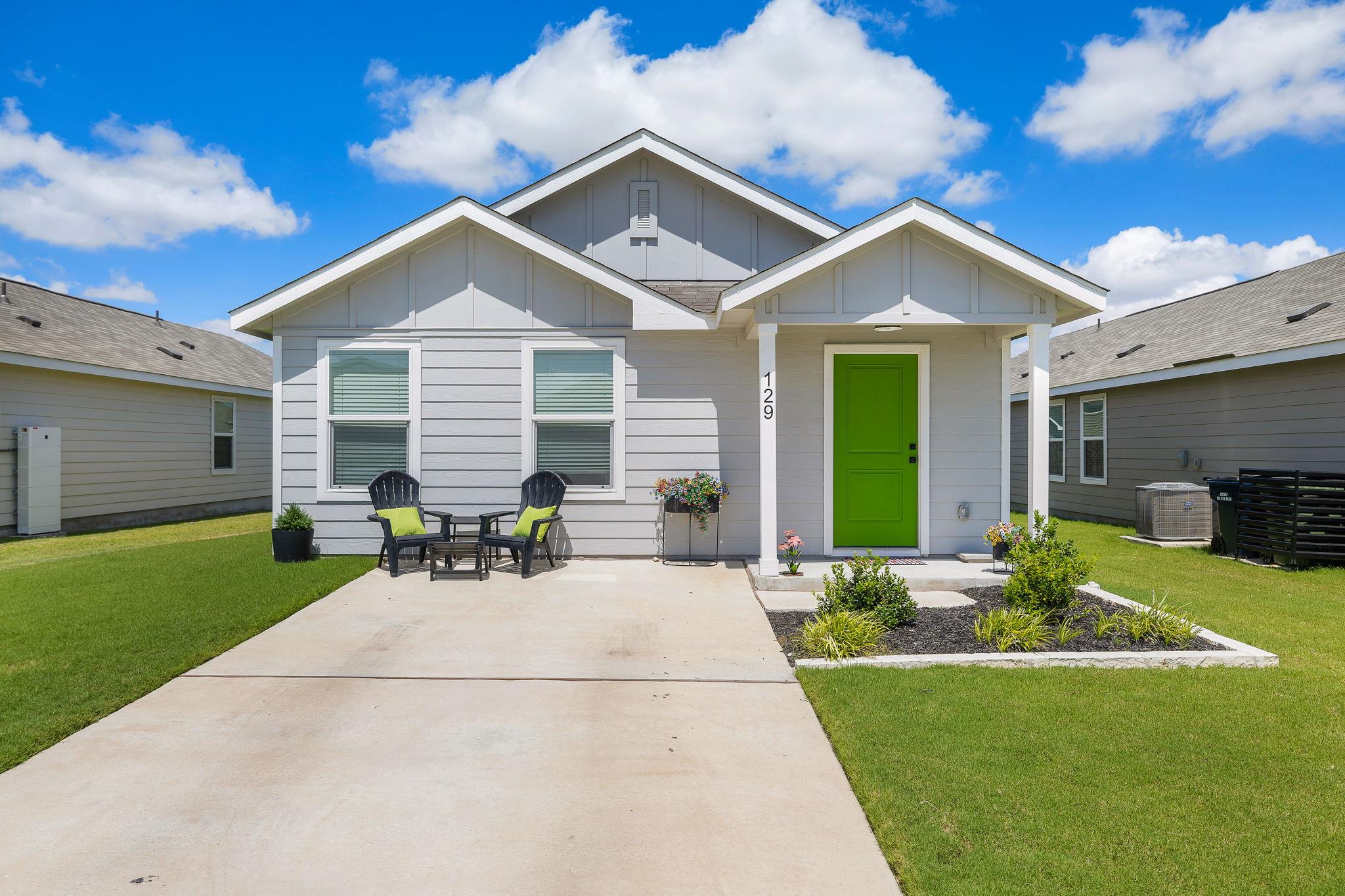 A vibrant green door welcomes you to this charmin
