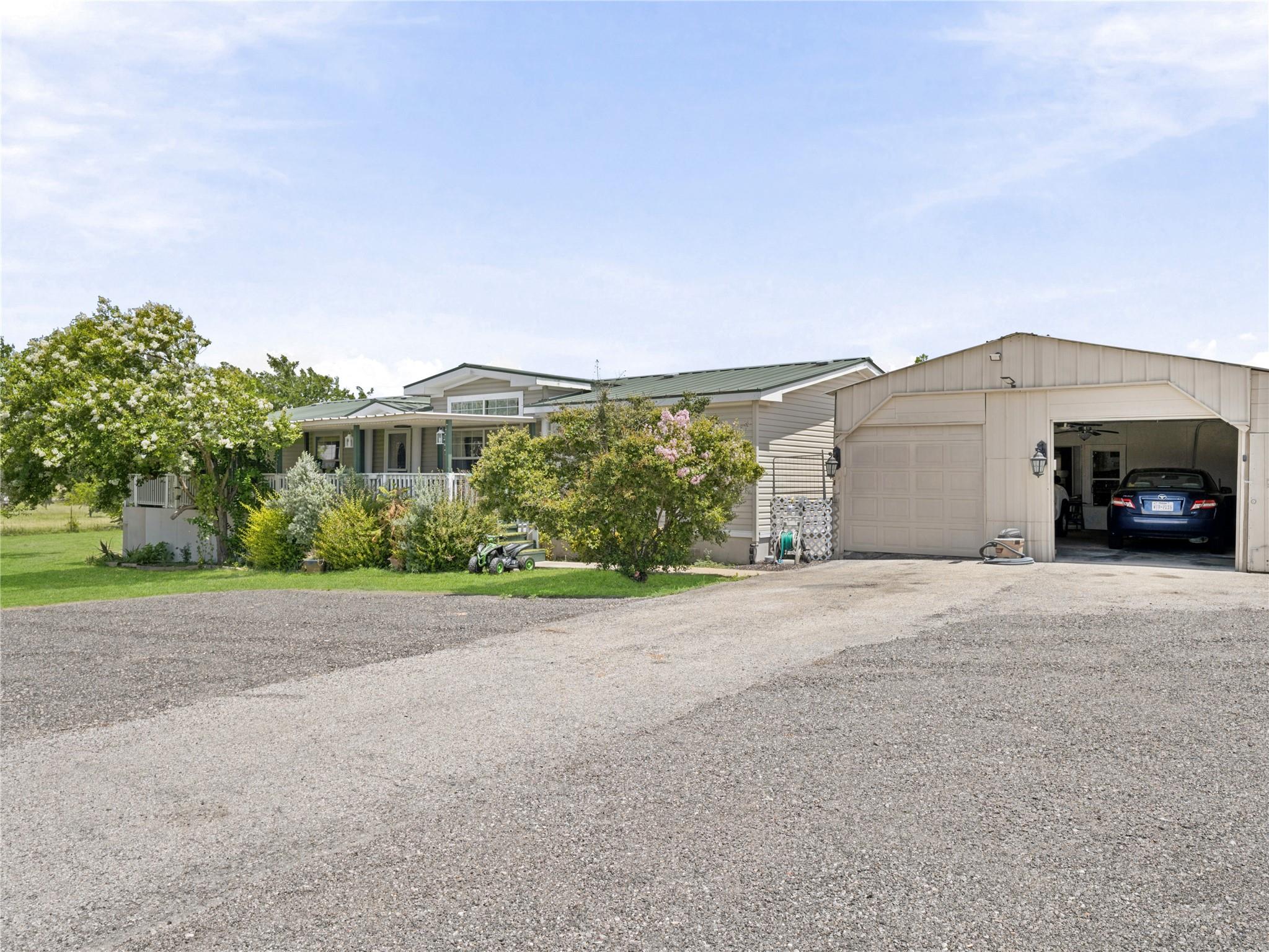 A well-maintained residence with a gravel drivewa