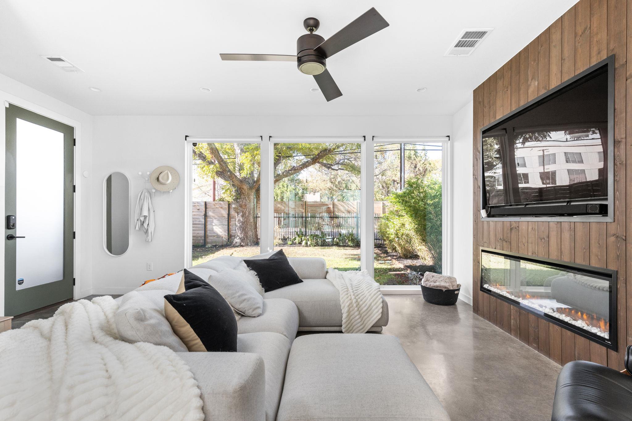 A modern fireplace wall with natural wood panelin
