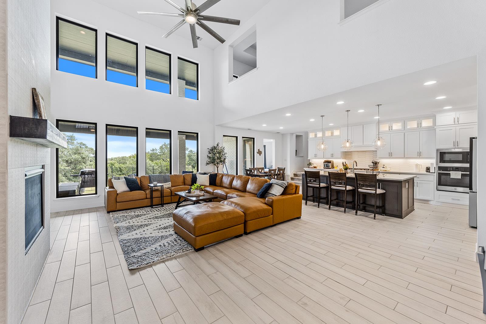 Living area with a fireplace, recessed lighting, 