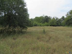 Mature trees frame a sprawling grassy expanse, pe