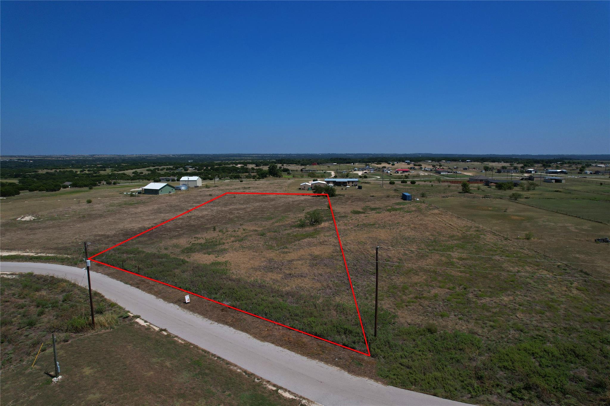 A spacious countryside lot offers open terrain an
