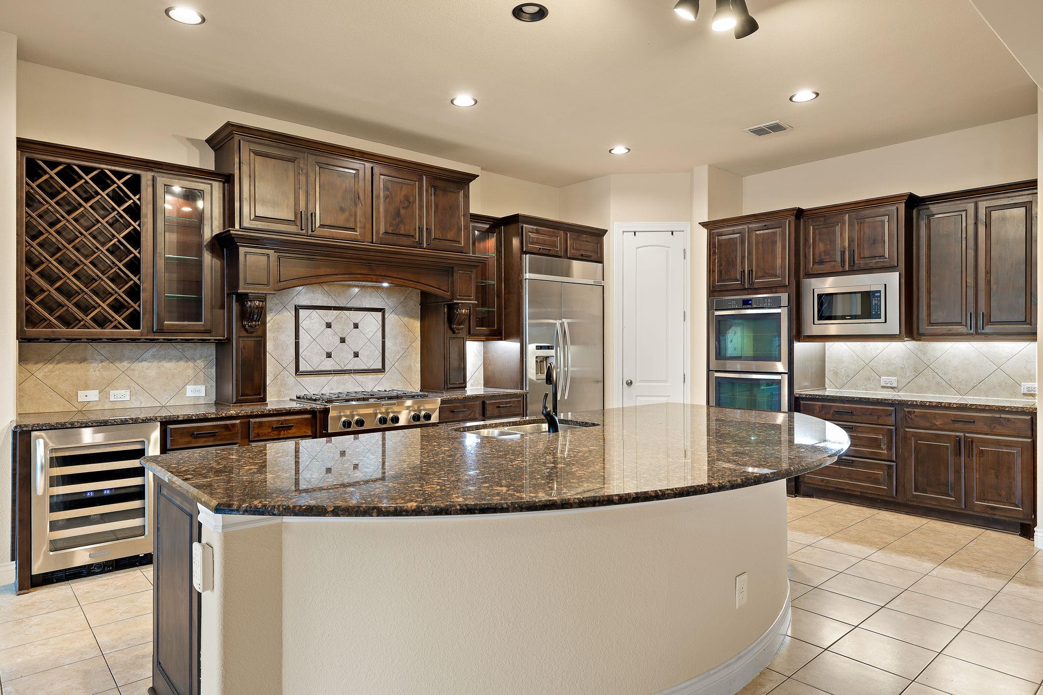 Kitchen with backsplash, light tile patterned flo