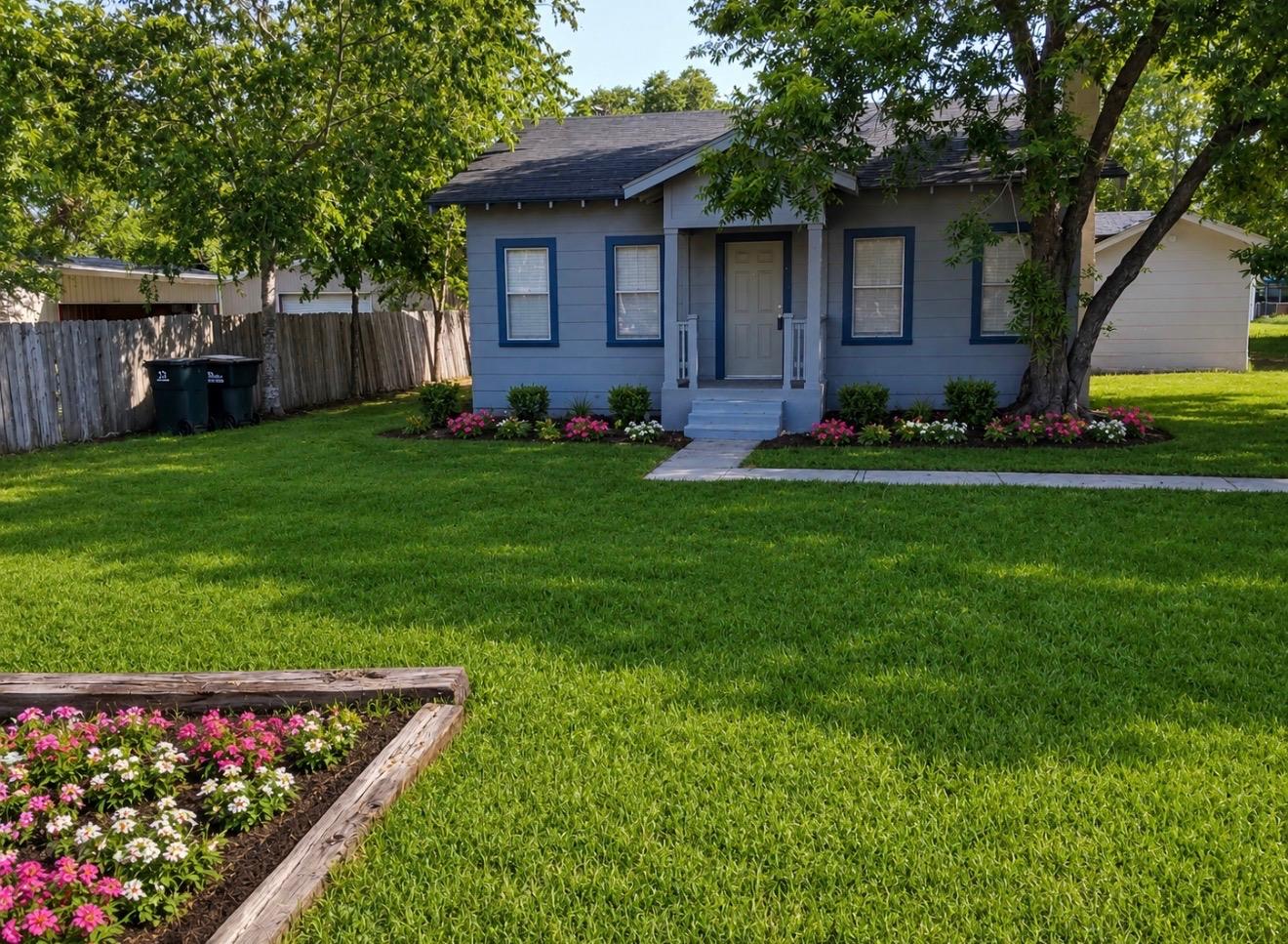 A neatly maintained front yard with vibrant flora