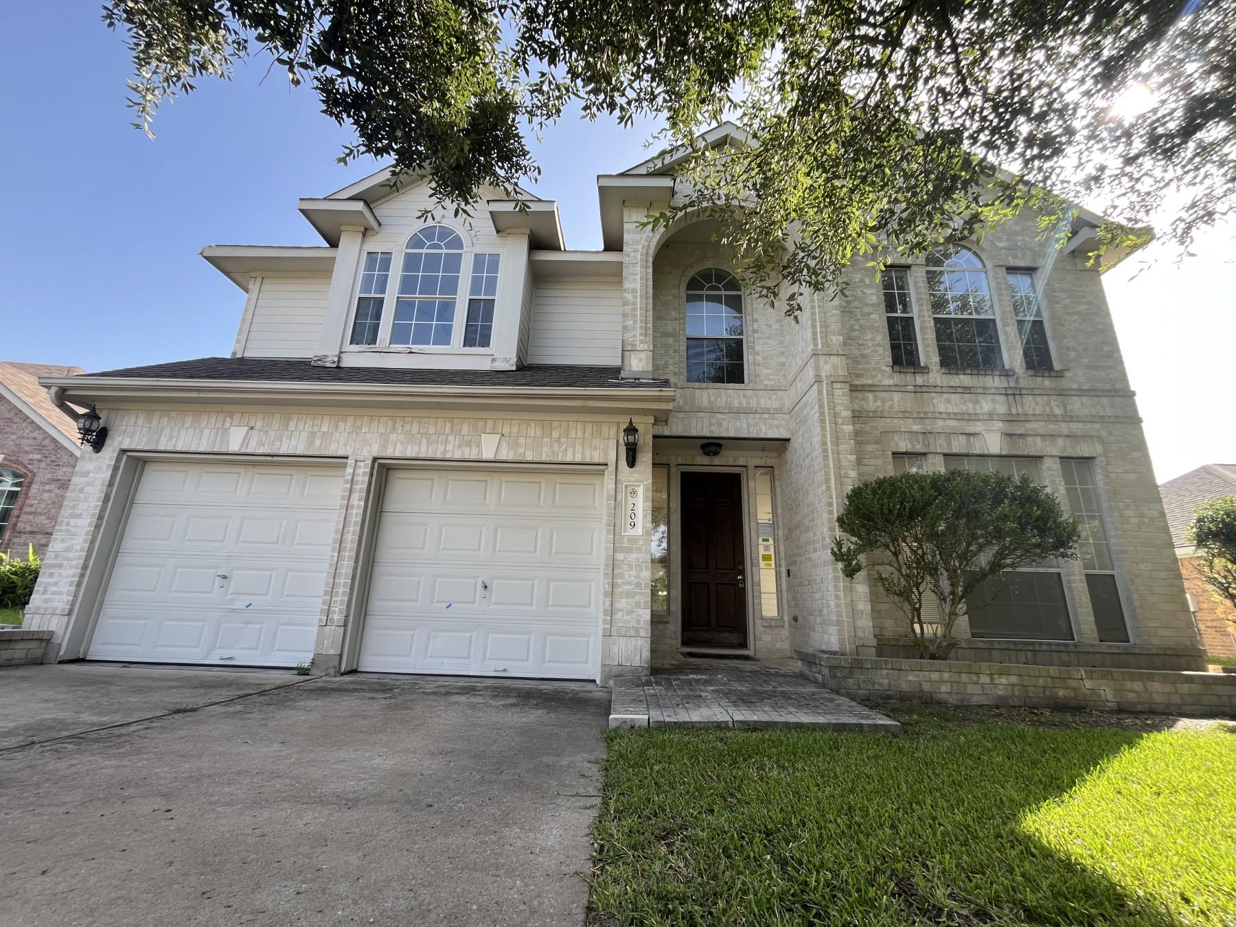 A classic brick-front residence welcomes with an 