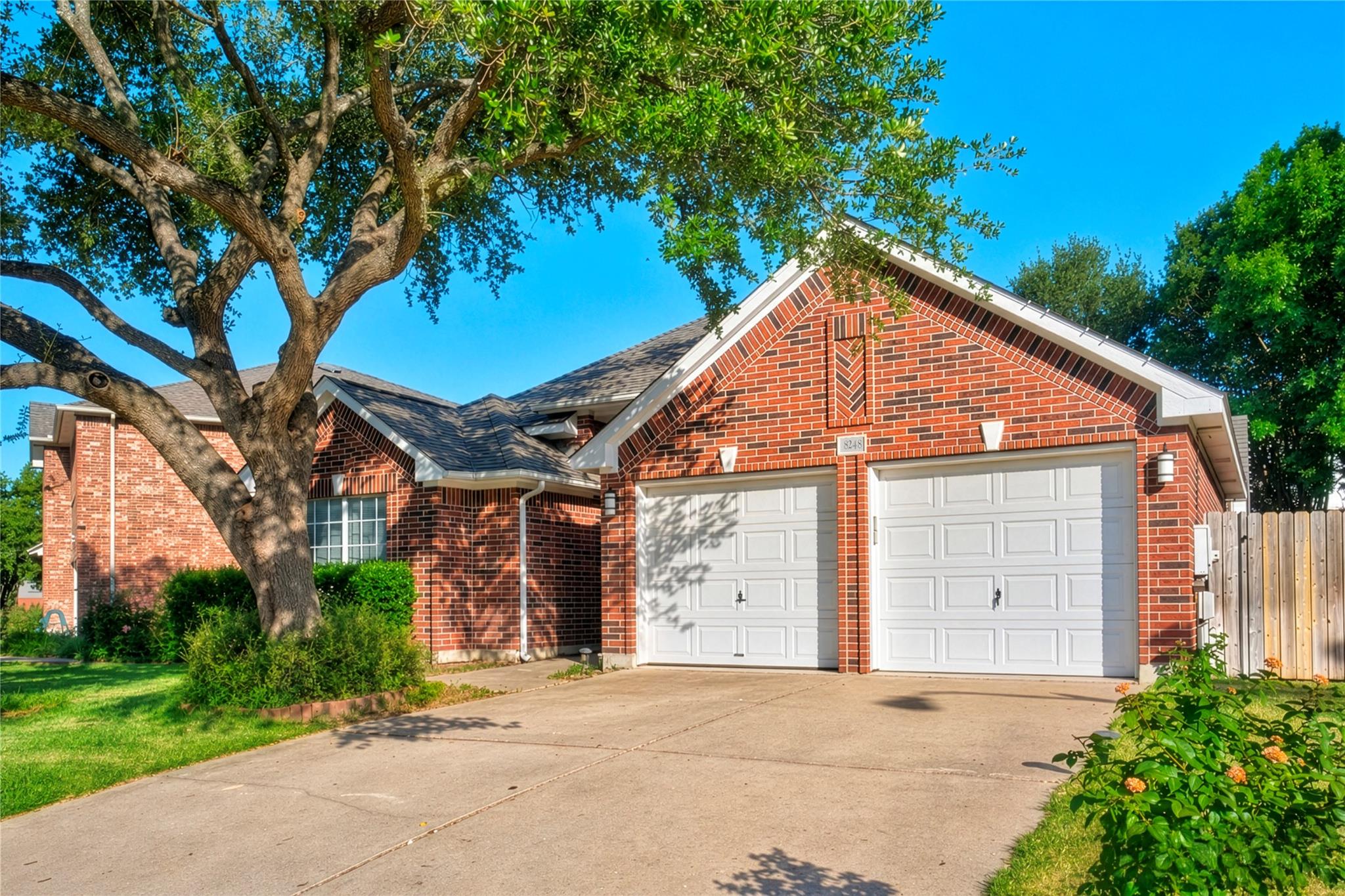 A classic brick exterior with a two-car garage aw