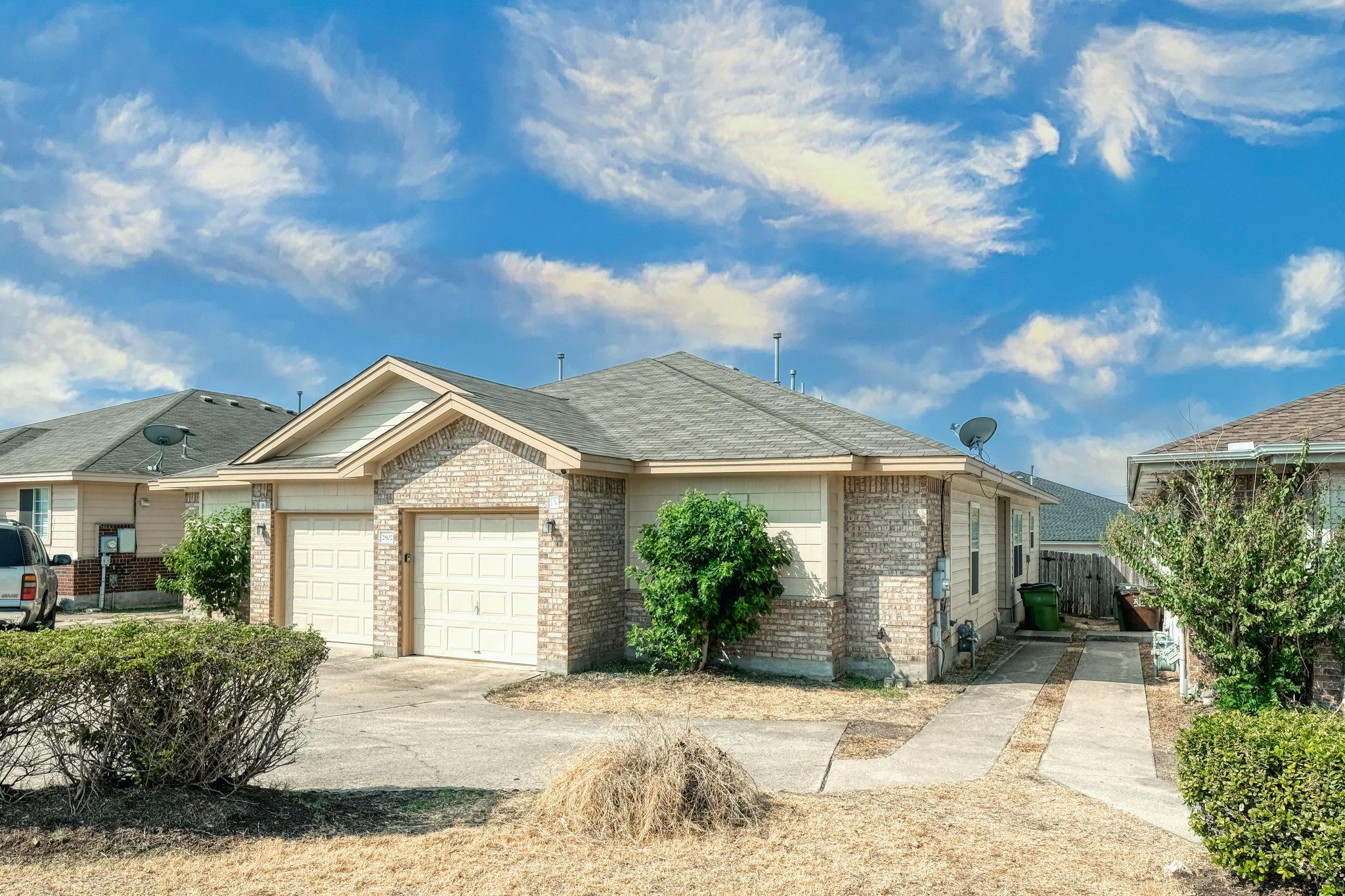 A classic brick and siding duplex presents a char
