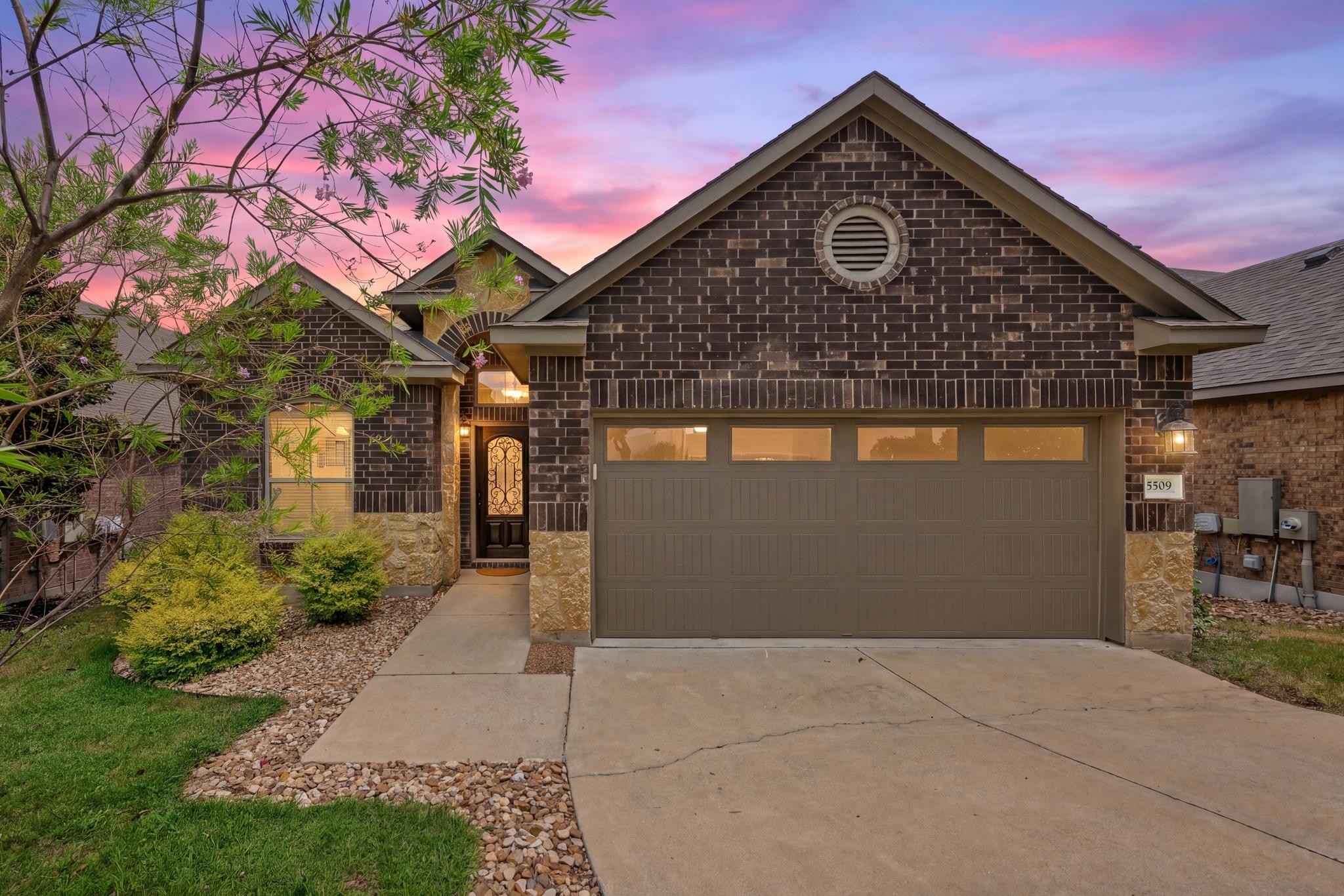 Brick and stone accents elevate the exterior of t