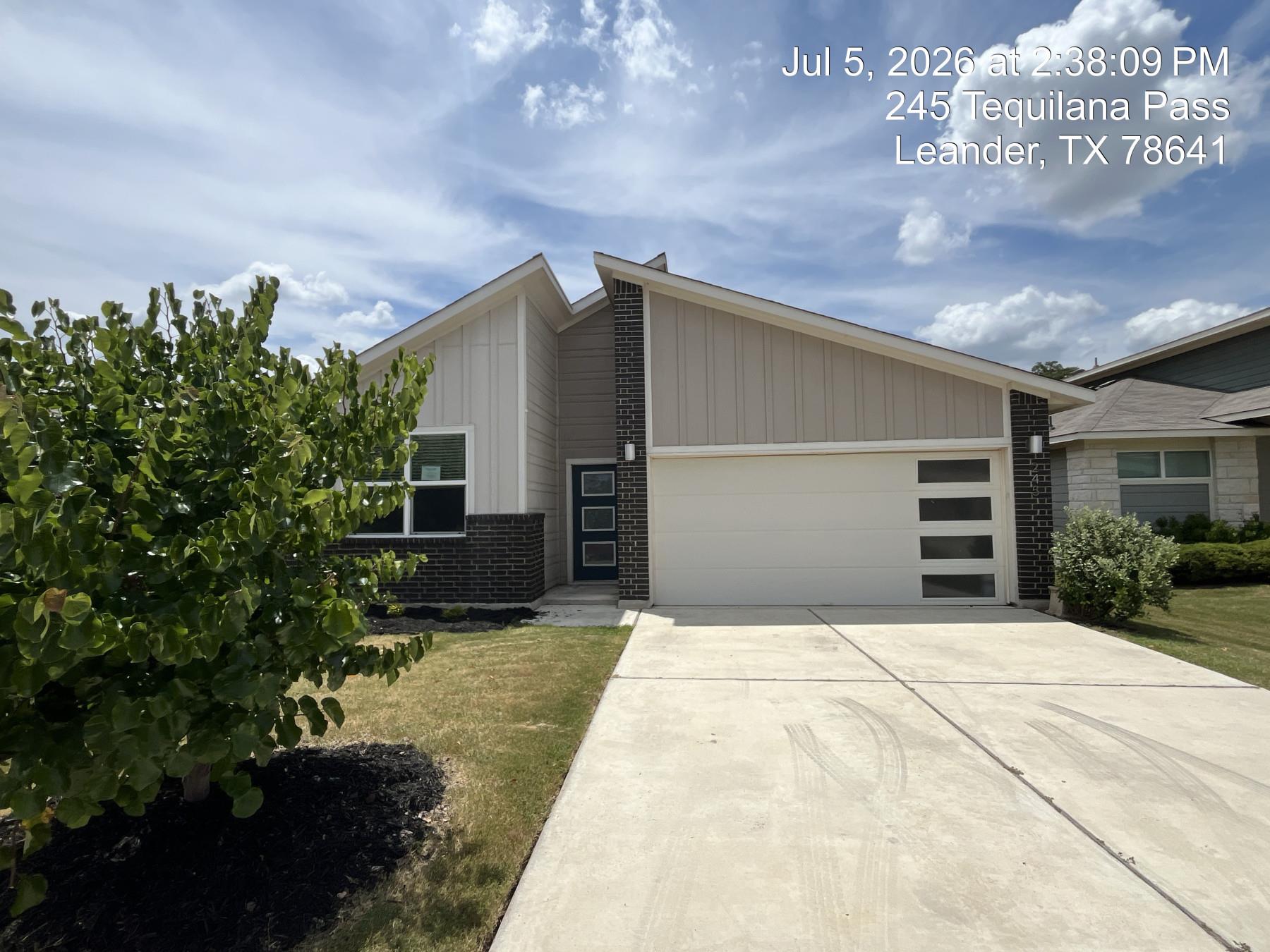 Modern façade with a clean-lined garage and a wel