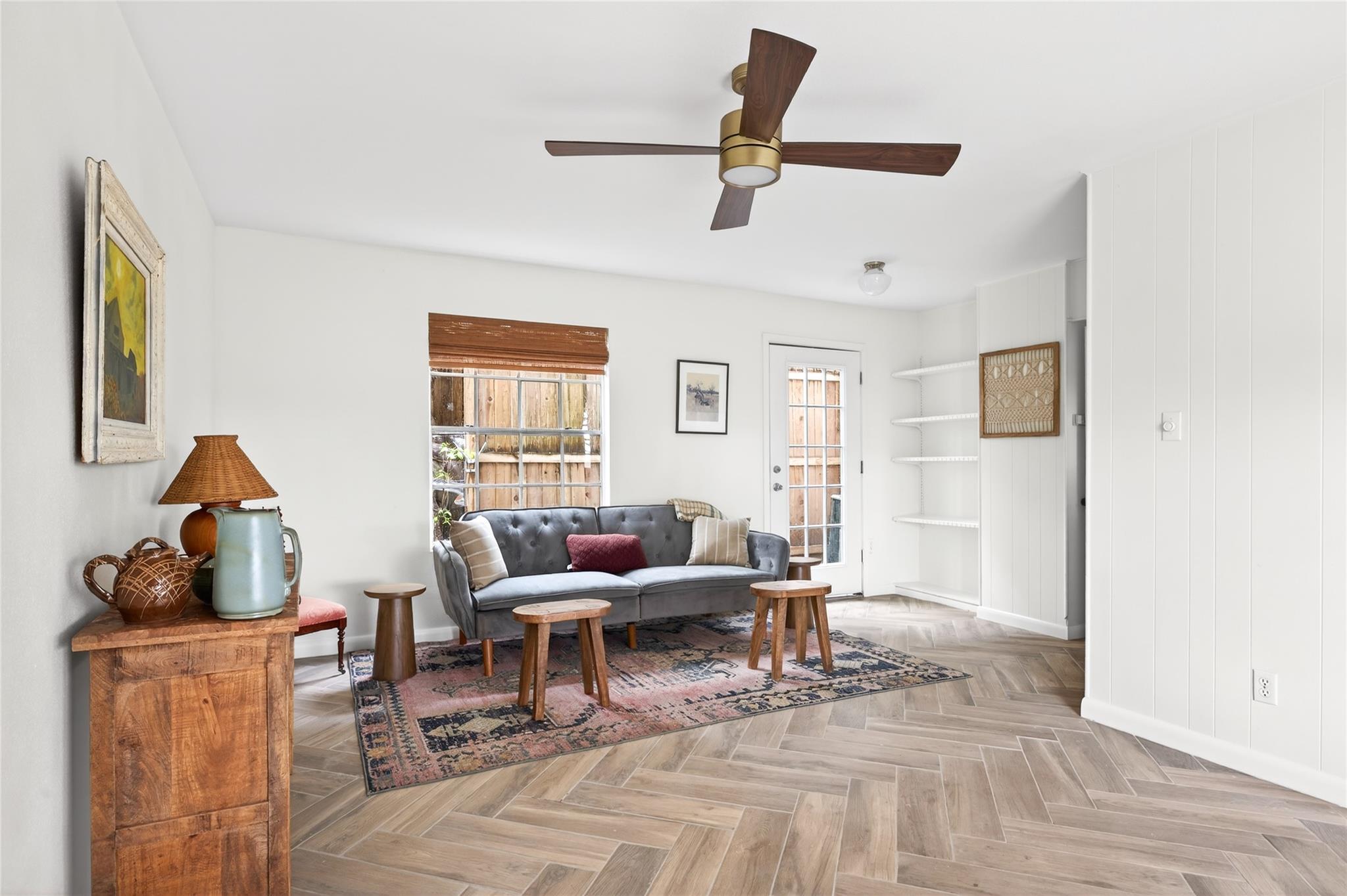 Herringbone pattern flooring anchors this light-f