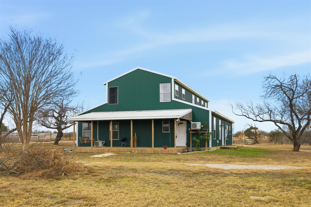 Green siding defines this appealing rural residen