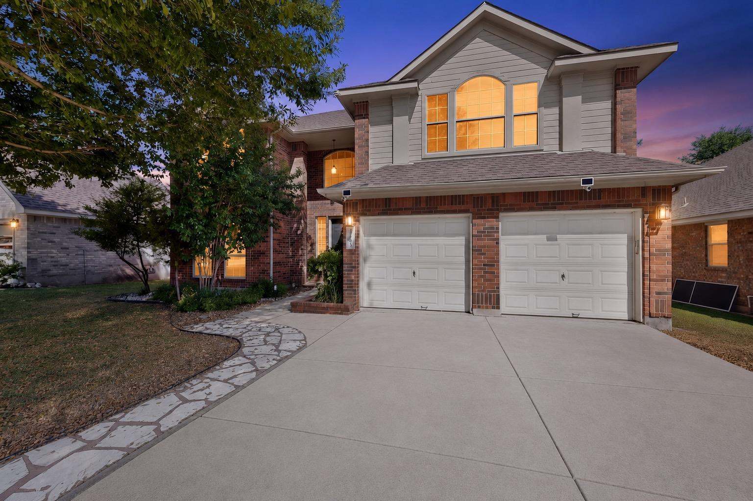 A welcoming brick and siding home presents a conc