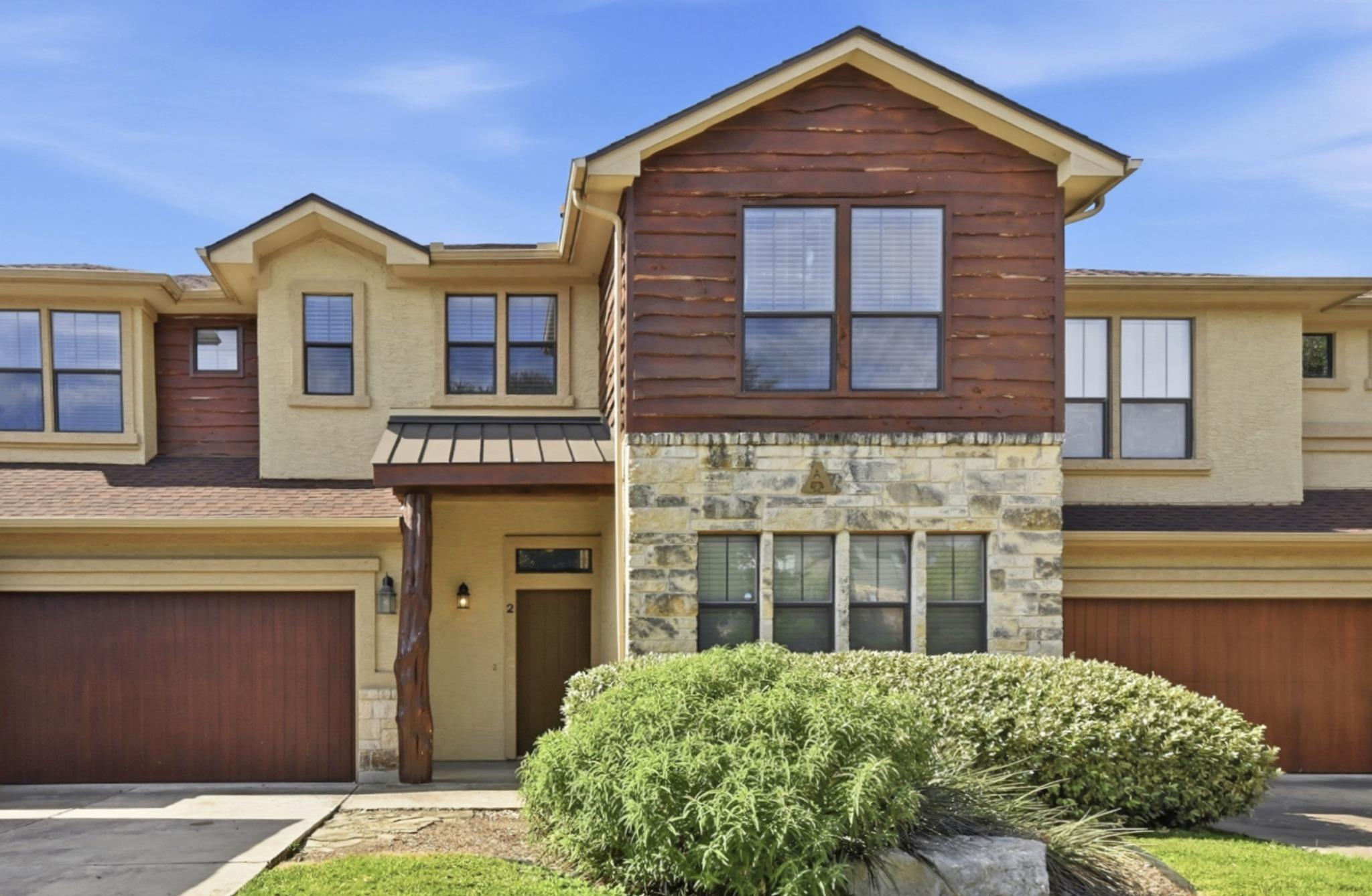 A striking exterior combines stucco, stone, and w