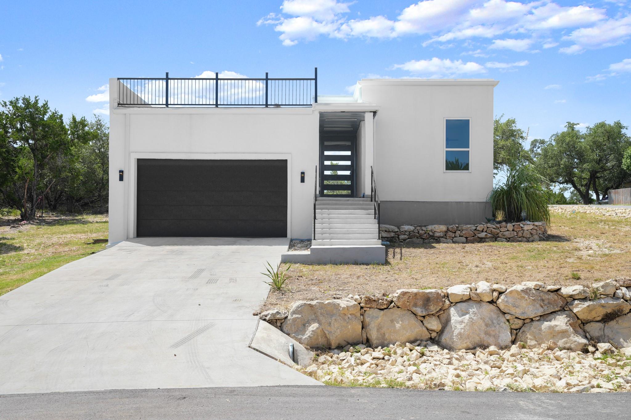 A striking modern facade with a broad driveway an