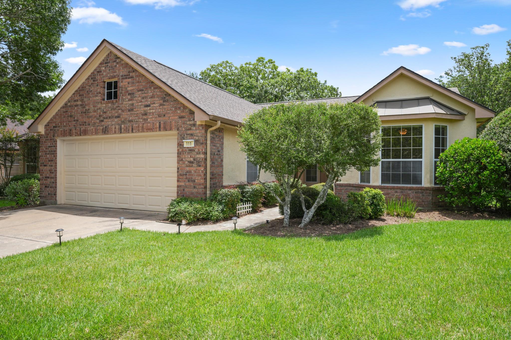 A well-maintained lawn welcomes you to this invit