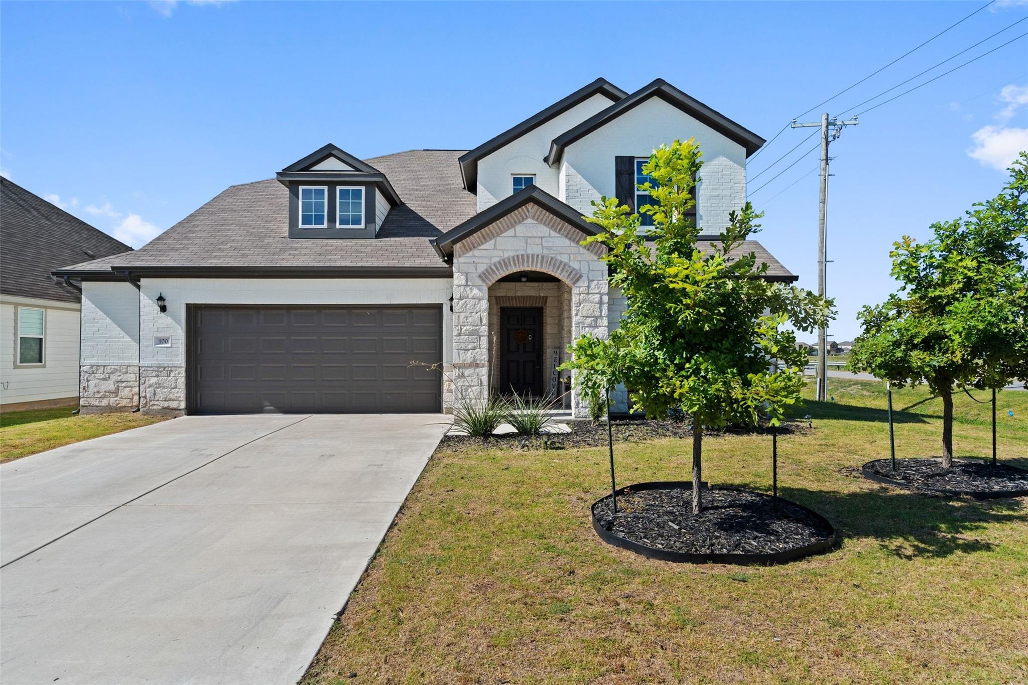 A newly constructed residence showcasing a stone 