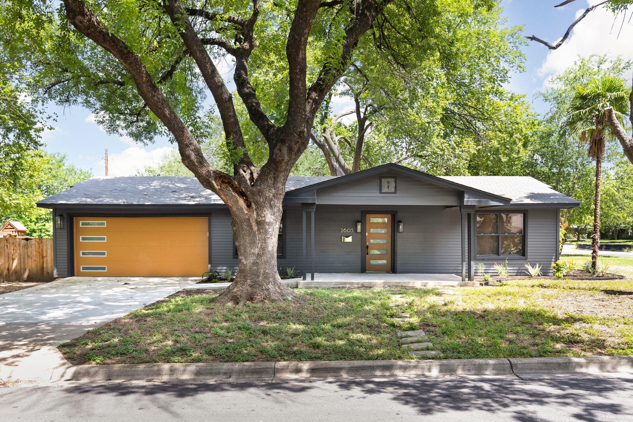 A striking gray residence boasts a modern garage 