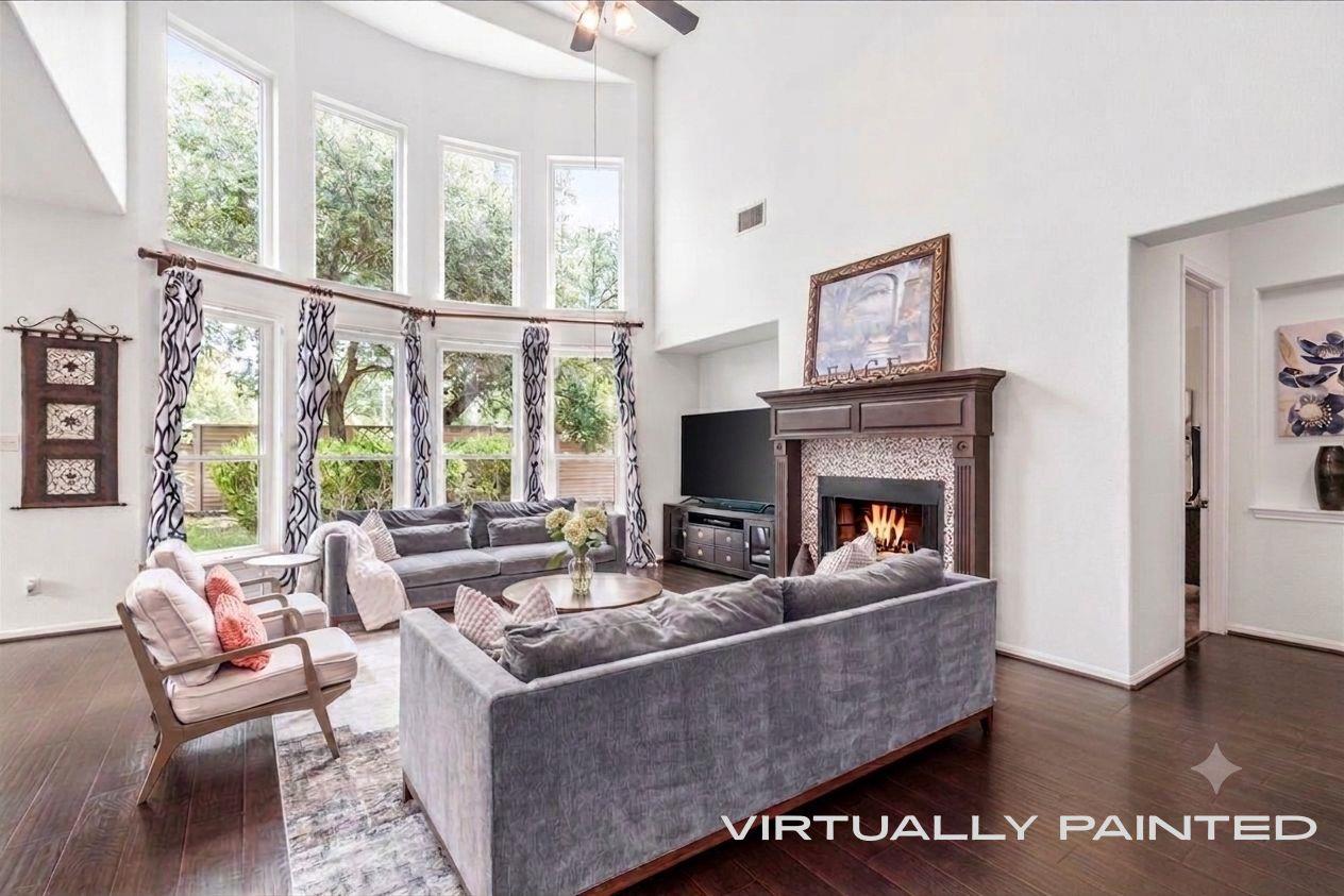 A spacious living area features high ceilings, da