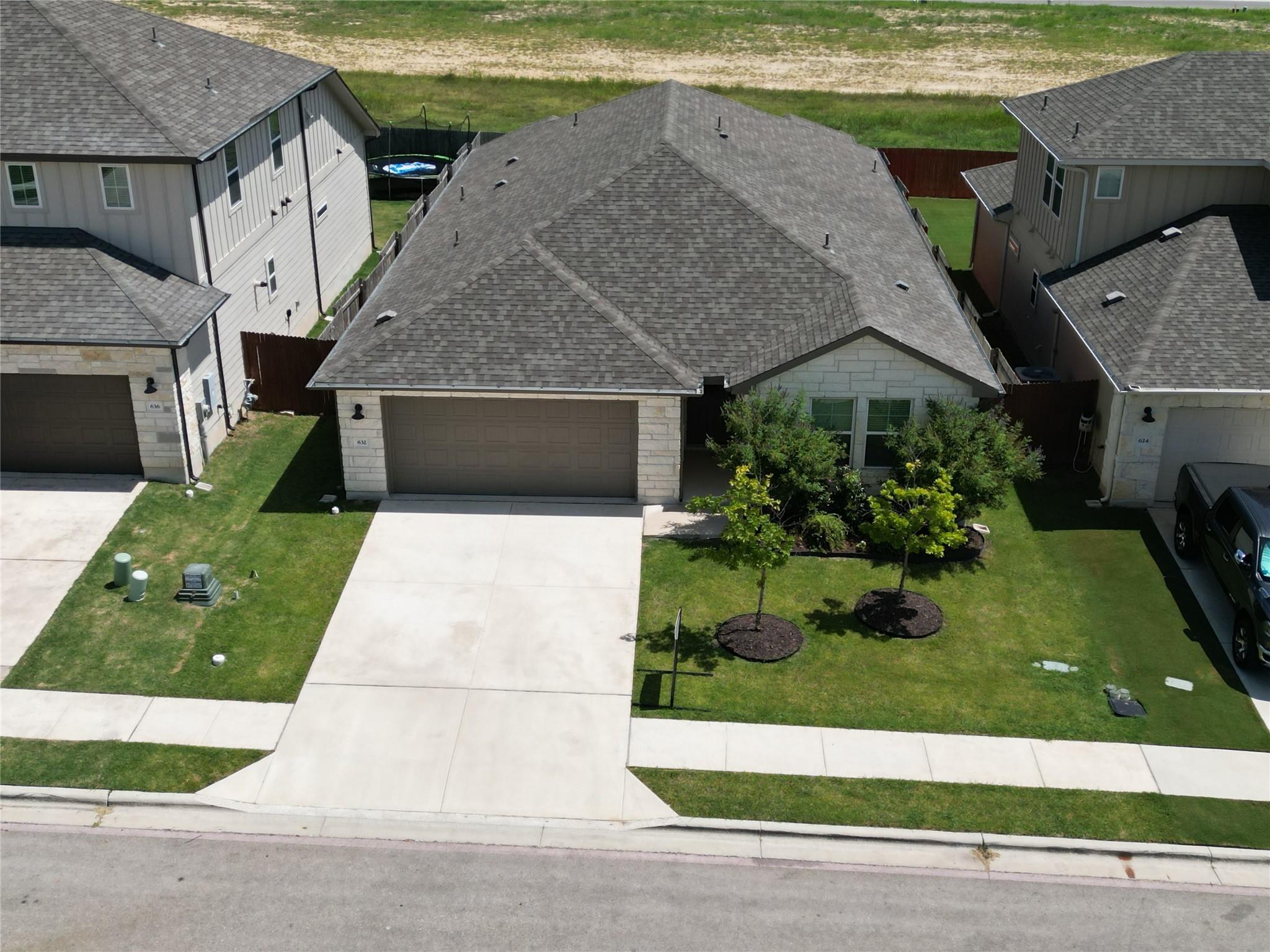 A neatly maintained front yard and inviting drive