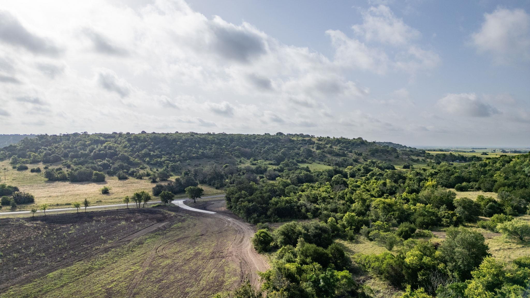 Vast, verdant landscape unfolds under a dynamic s