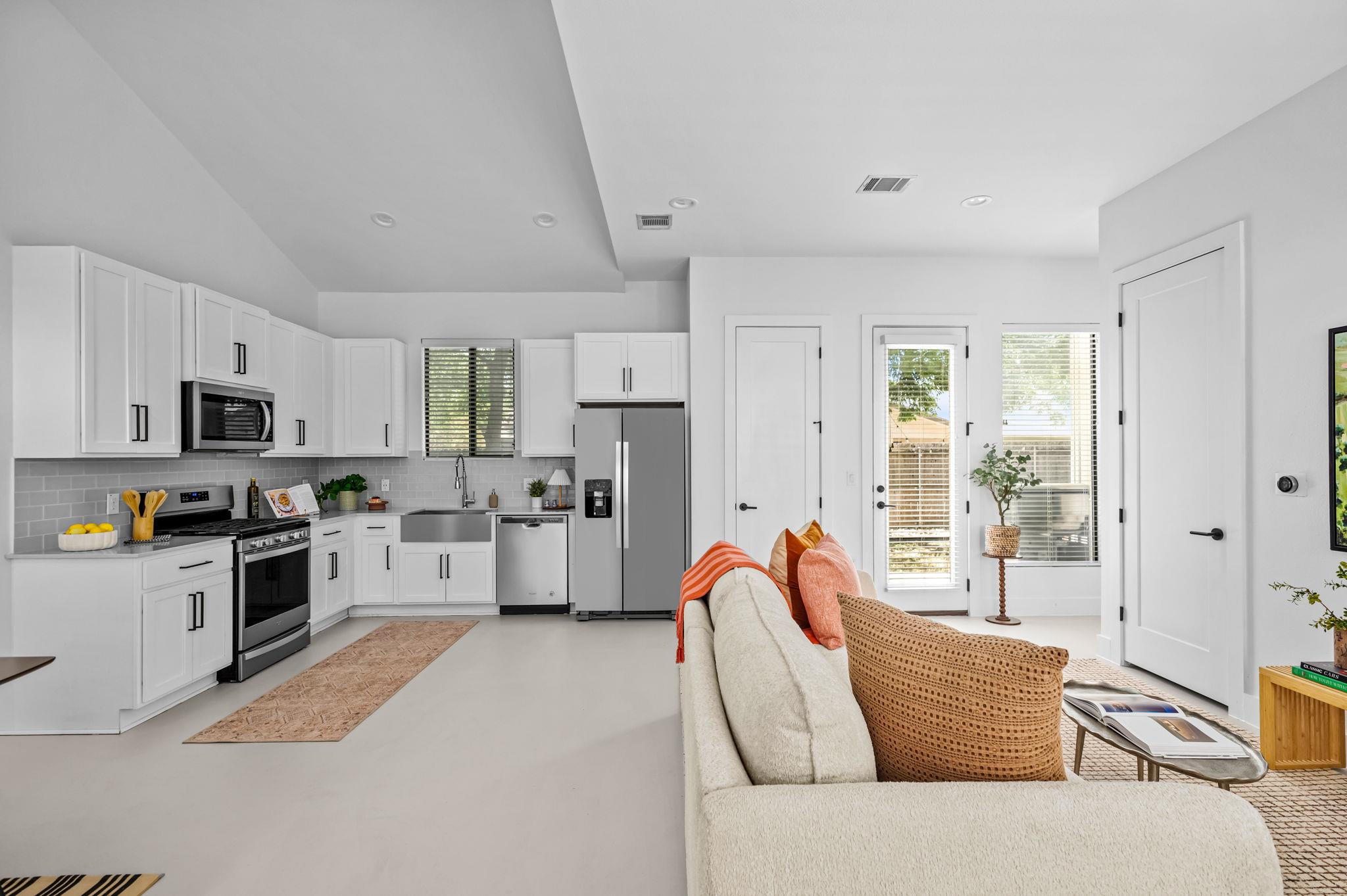 A sleek, contemporary kitchen with white cabinetr