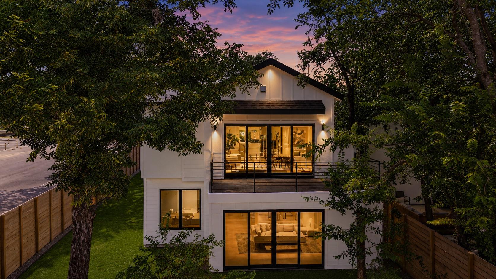 Dramatic sunset hues embrace this modern home, fe