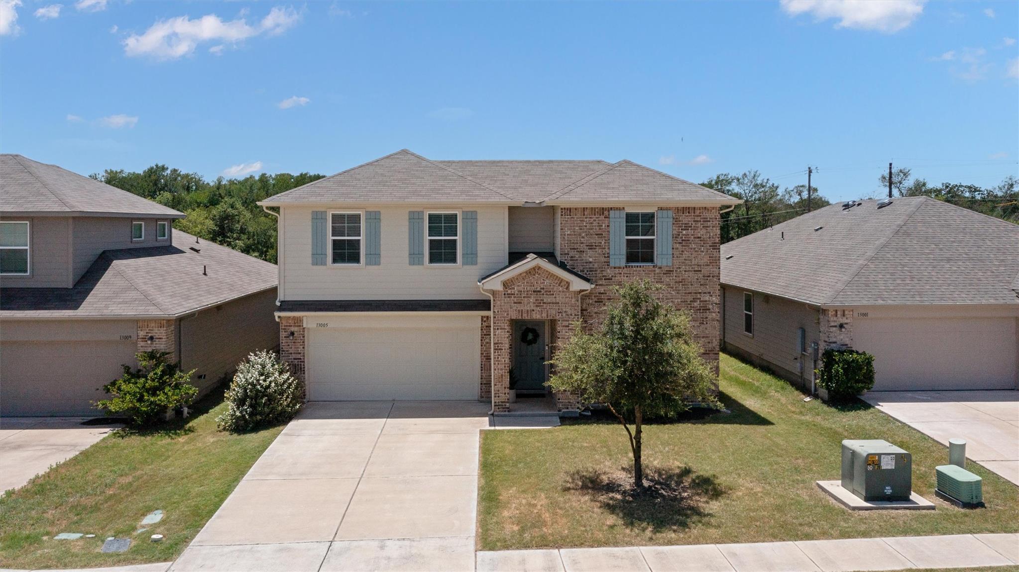 A classic brick and siding two-story home, with a