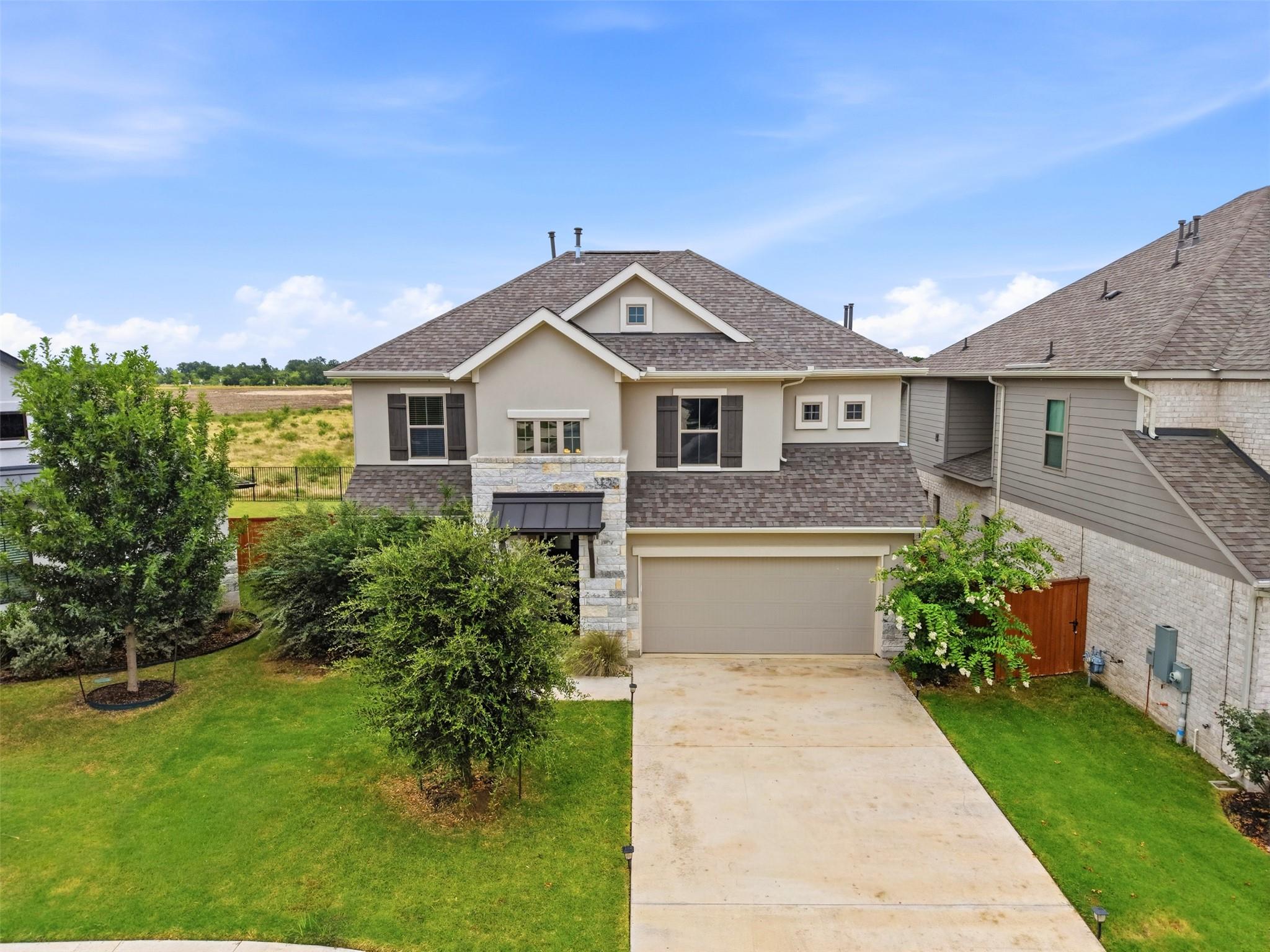 An inviting facade with a broad driveway and neat