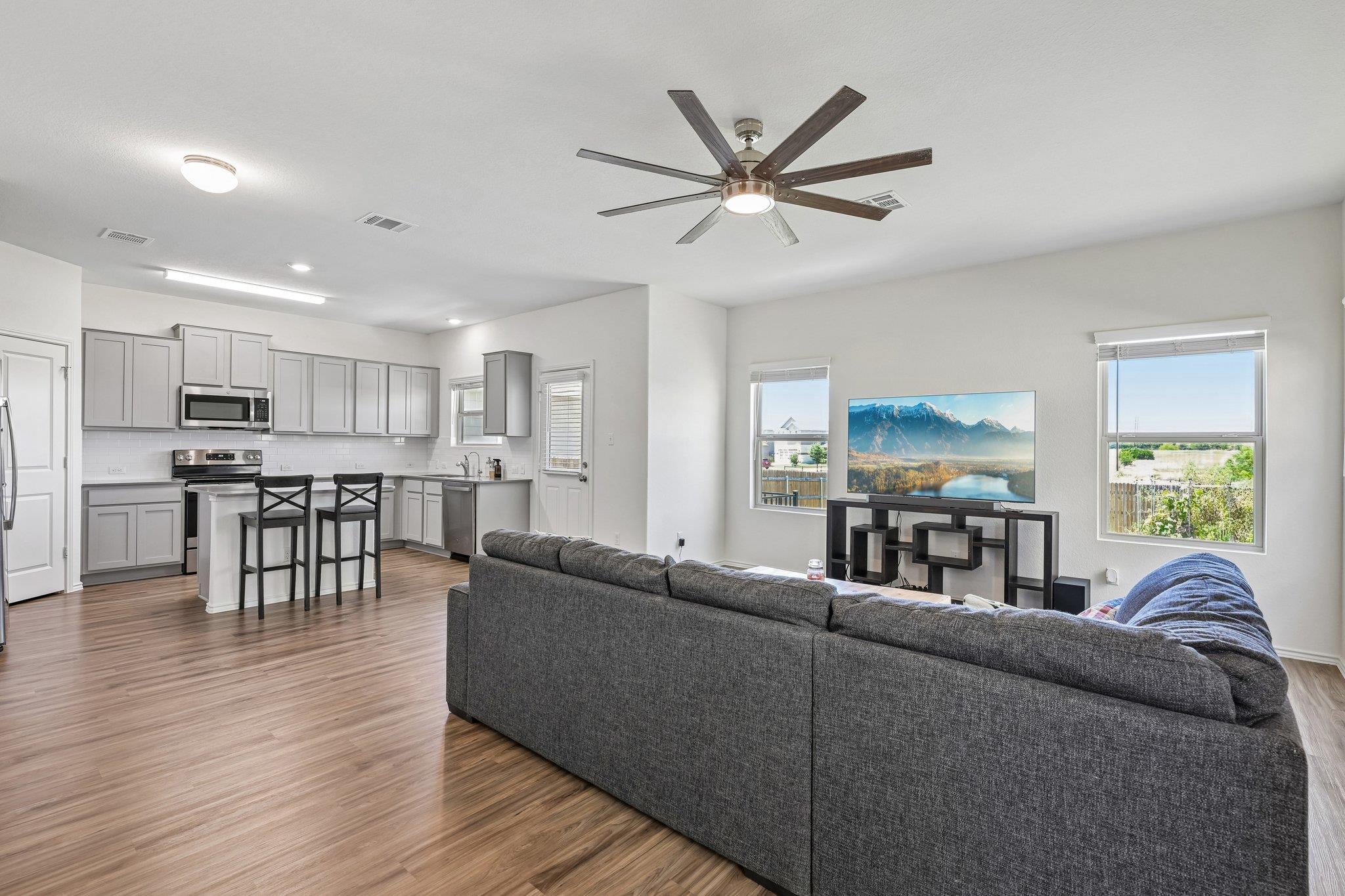 An open-concept living area flows into a kitchen 