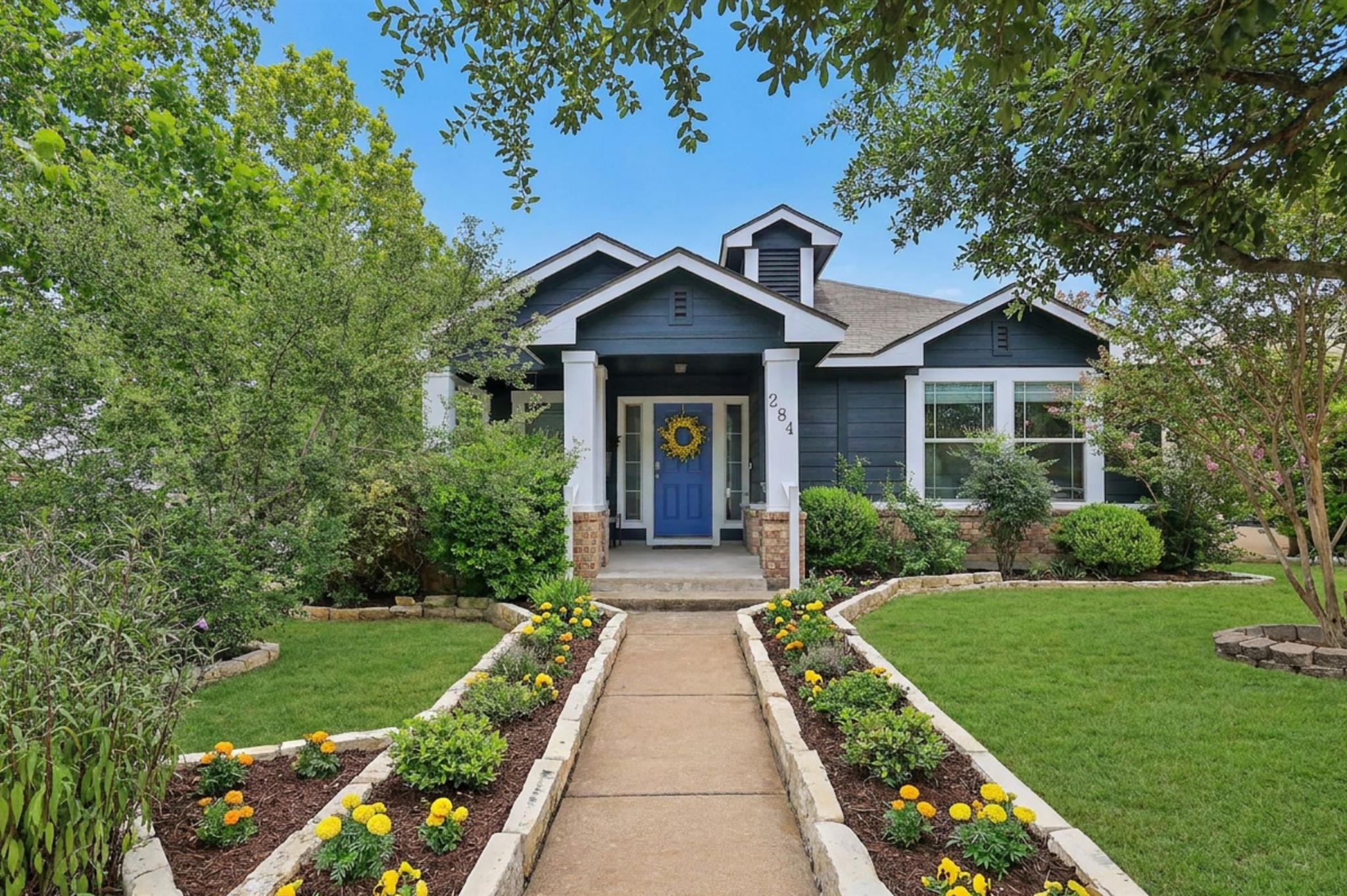 A welcoming stone pathway leads to a charming res