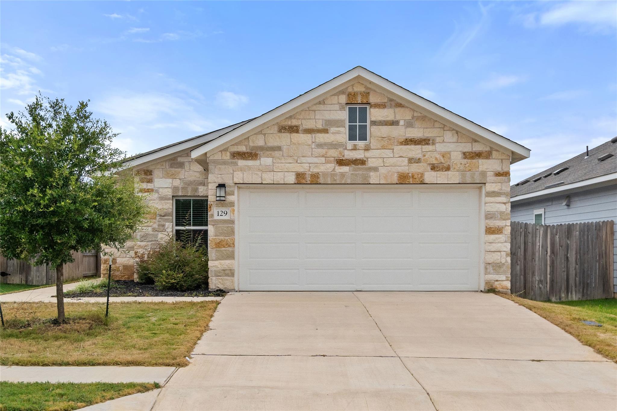 A charming single-story home with a stone and bri