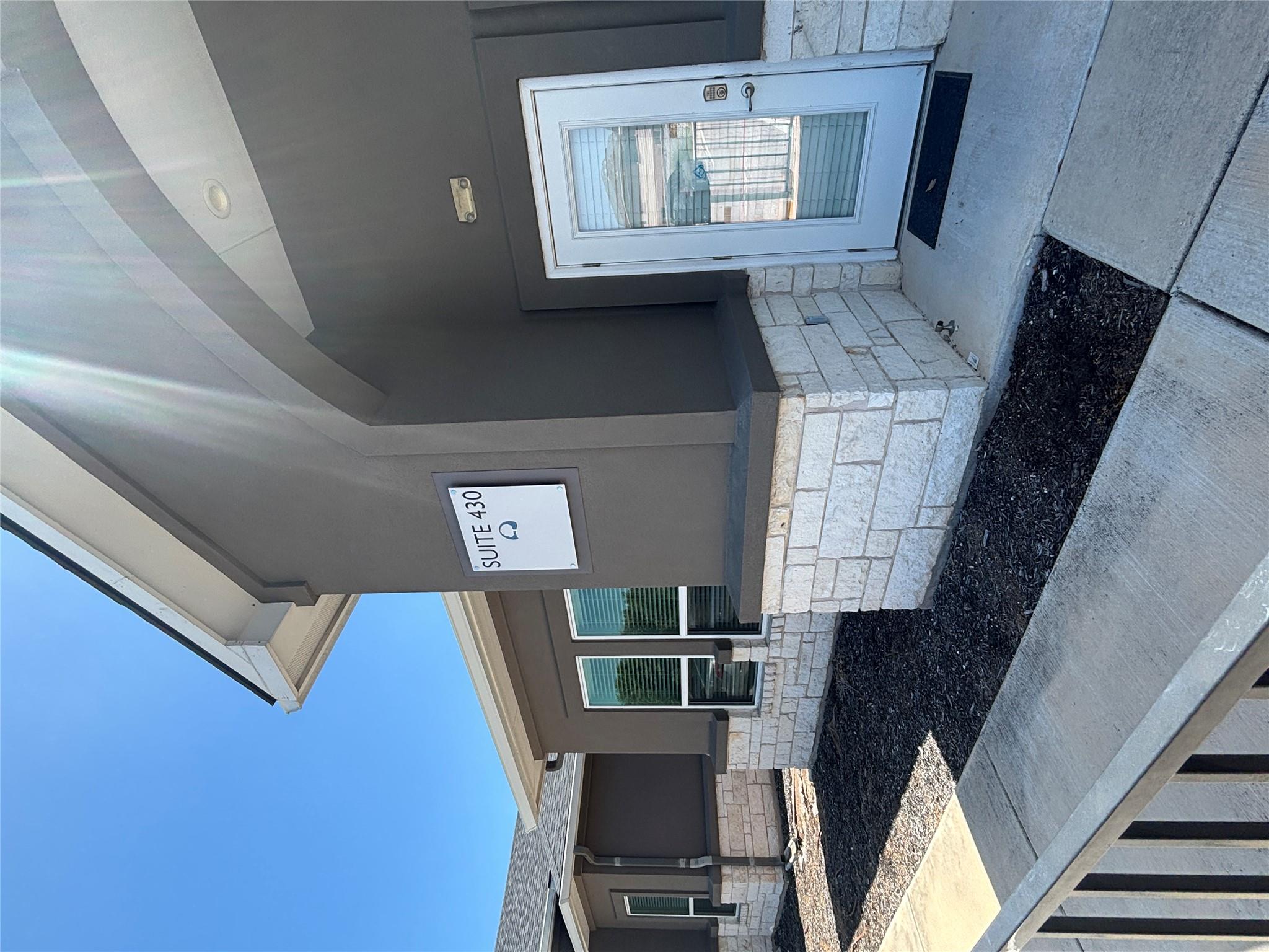 A welcoming entry featuring a durable stone and s