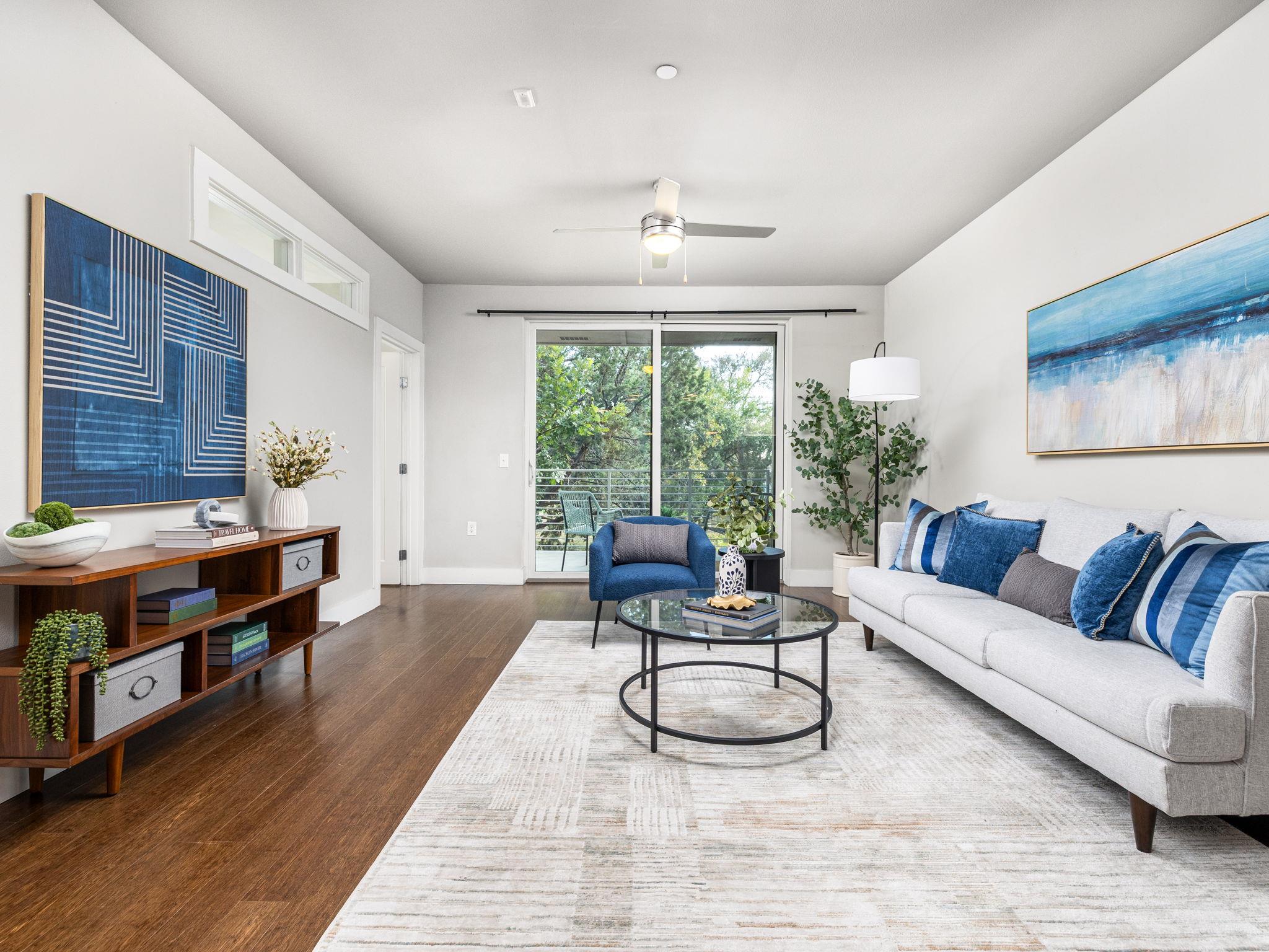 Rich hardwood flooring anchors the living area, o