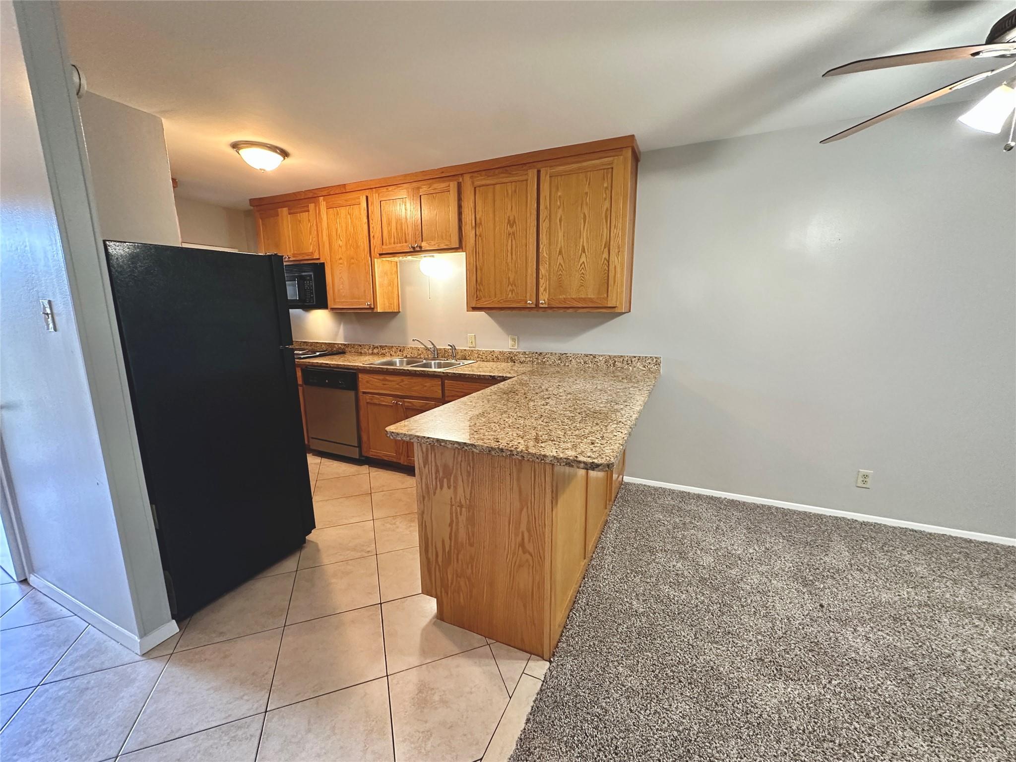 An inviting kitchen with a granite breakfast bar 