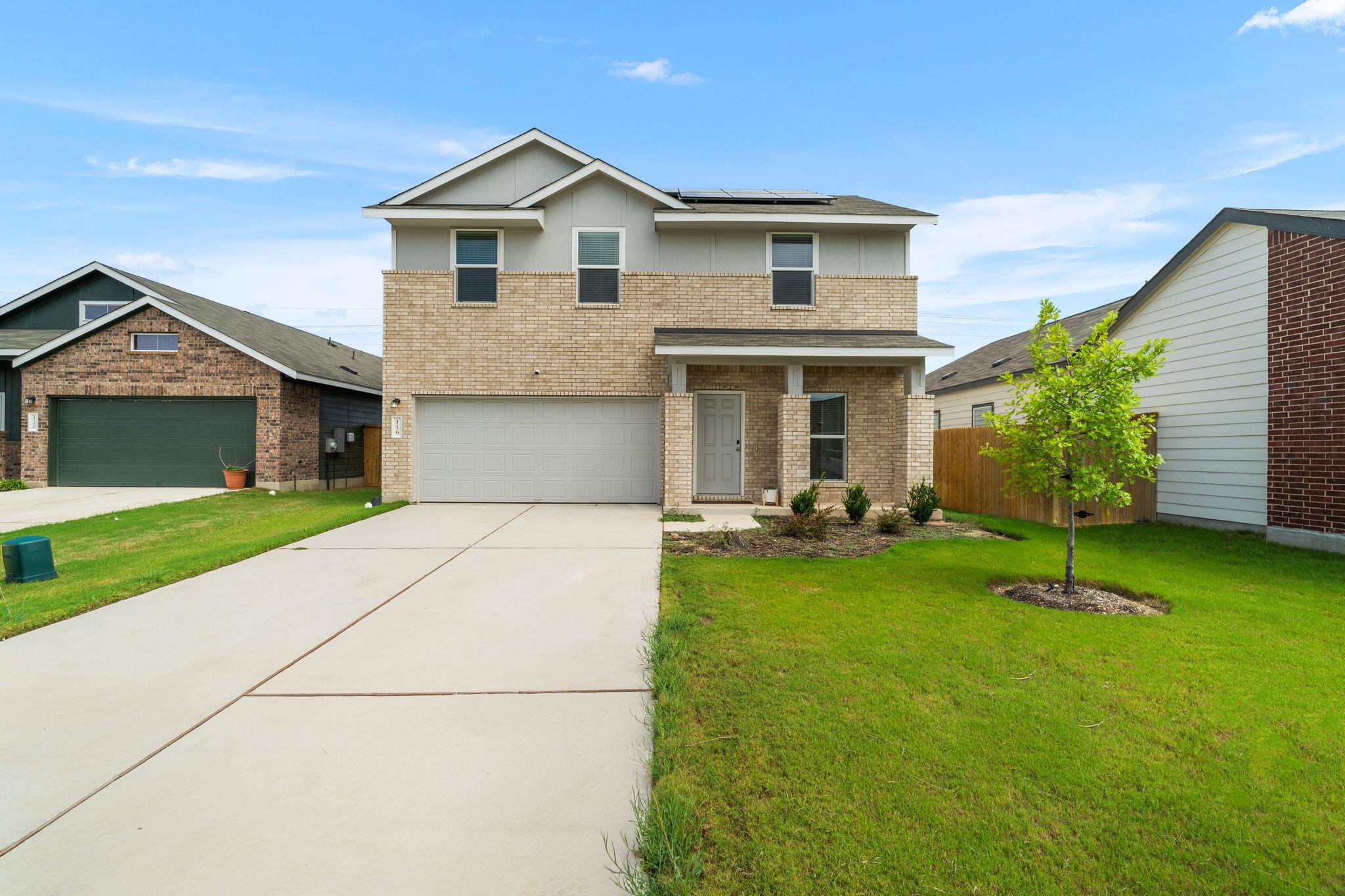 A well-maintained lawn and extended driveway enha