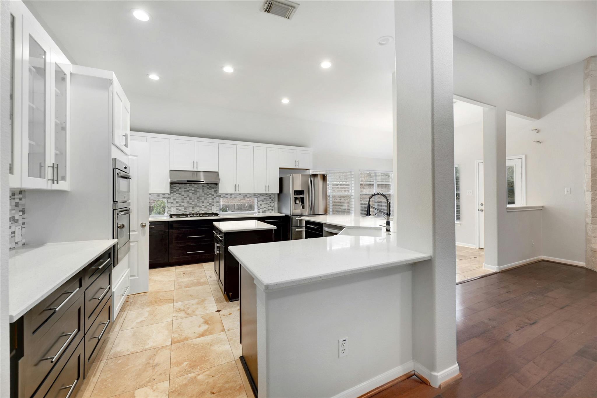 A well-appointed kitchen features rich cabinetry,