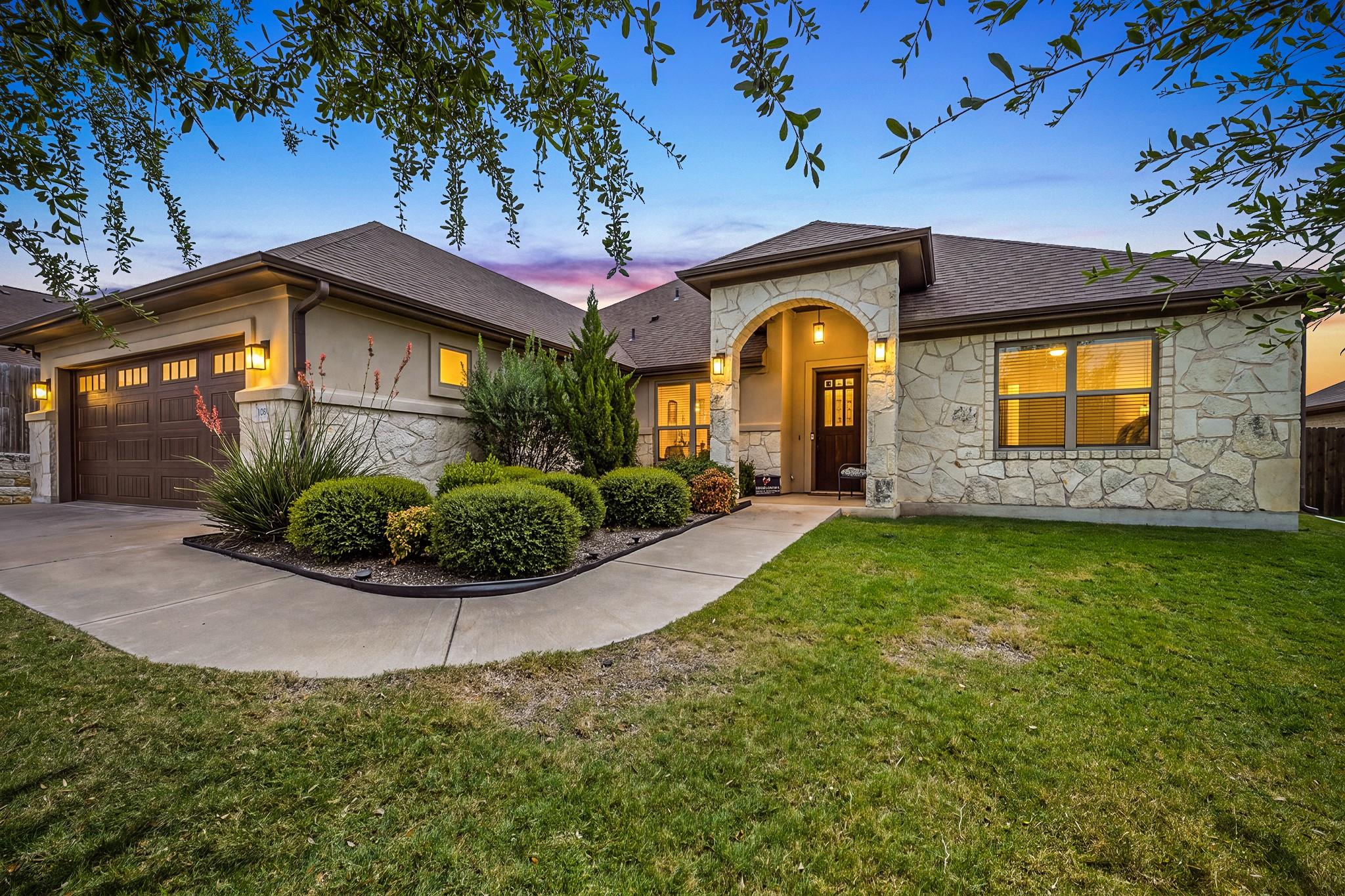 Natural stone accents and neat landscaping frame 