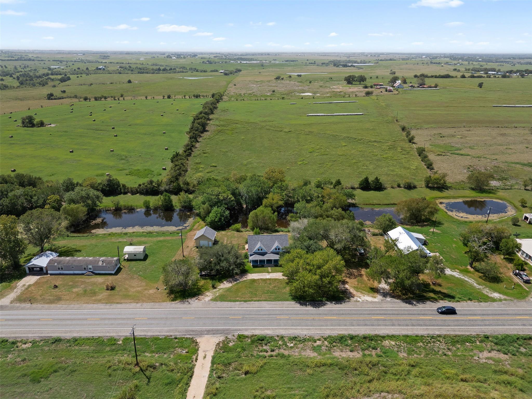 A scenic aerial view reveals a countryside homest