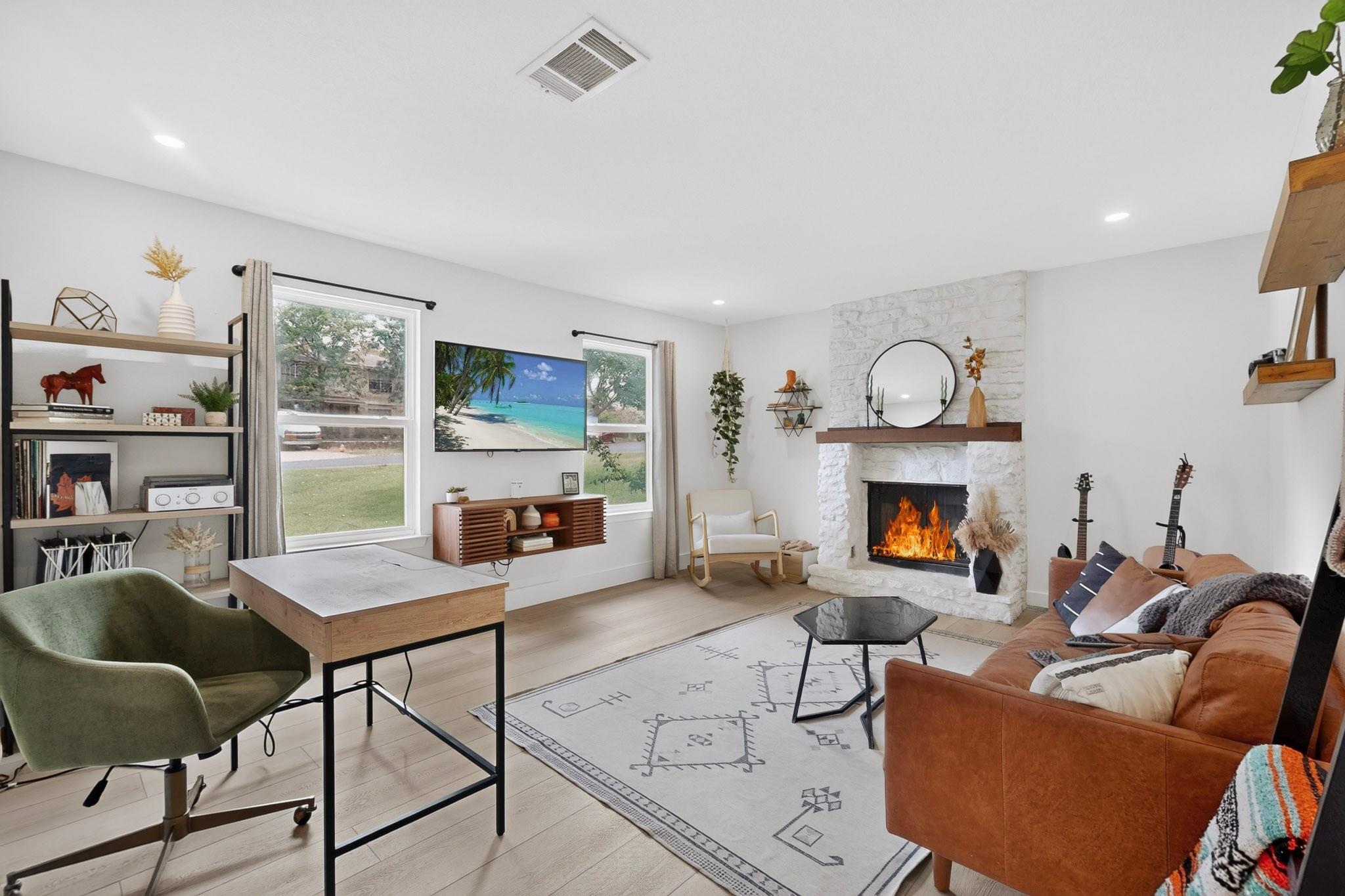 A luminous living room features a striking stone 