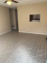 A welcoming living area boasts durable tile floor