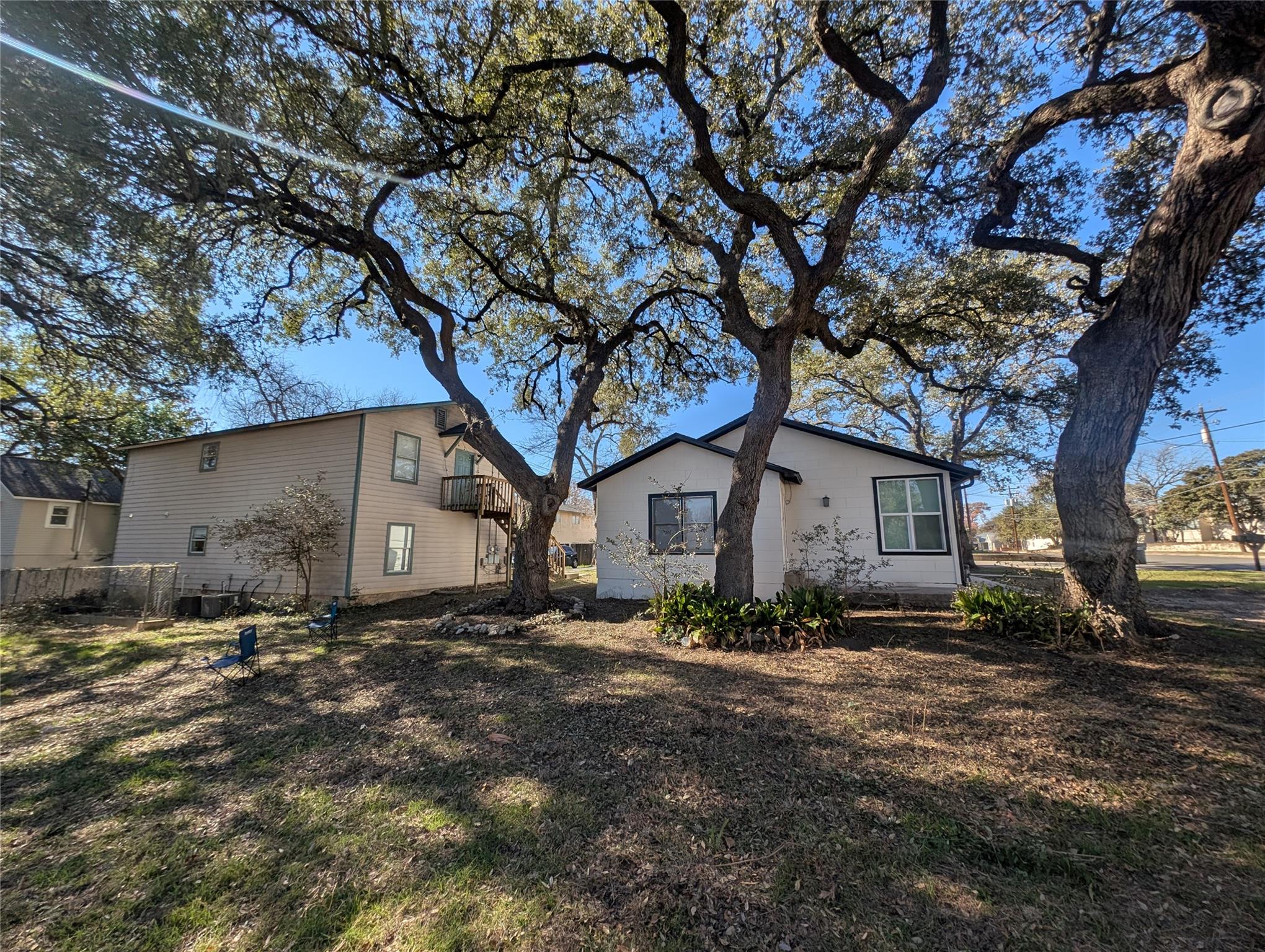 Mature trees shade this residence, featuring a se