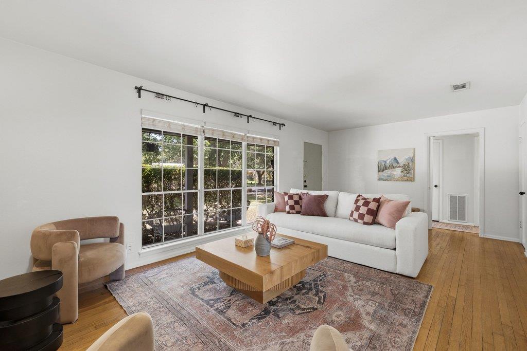 Sun-filled living space with rich hardwood floori